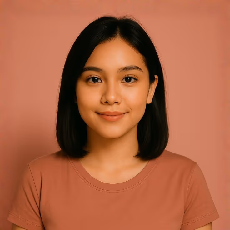 Young woman with straight black hair wearing a terracotta-colored shirt against a matching terracotta background.