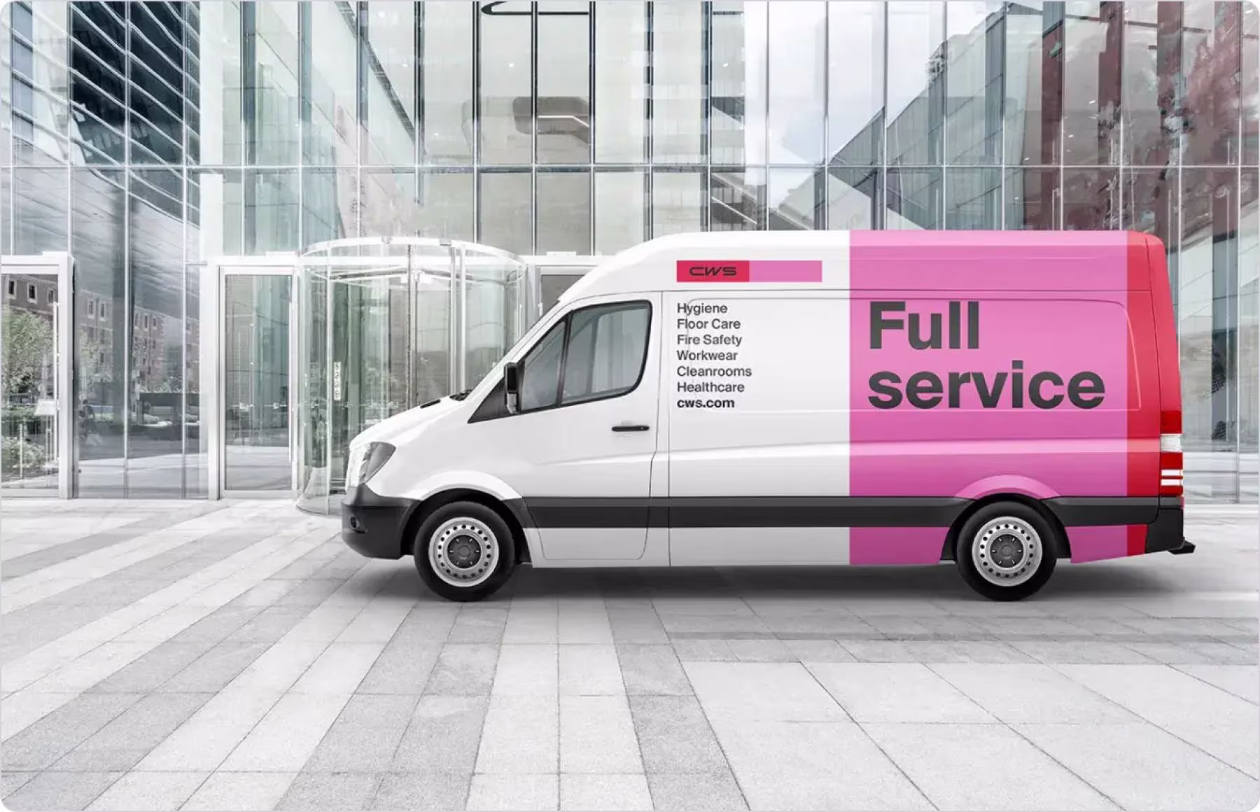 Two men standing and reviewing a tablet together in a softly lit office.