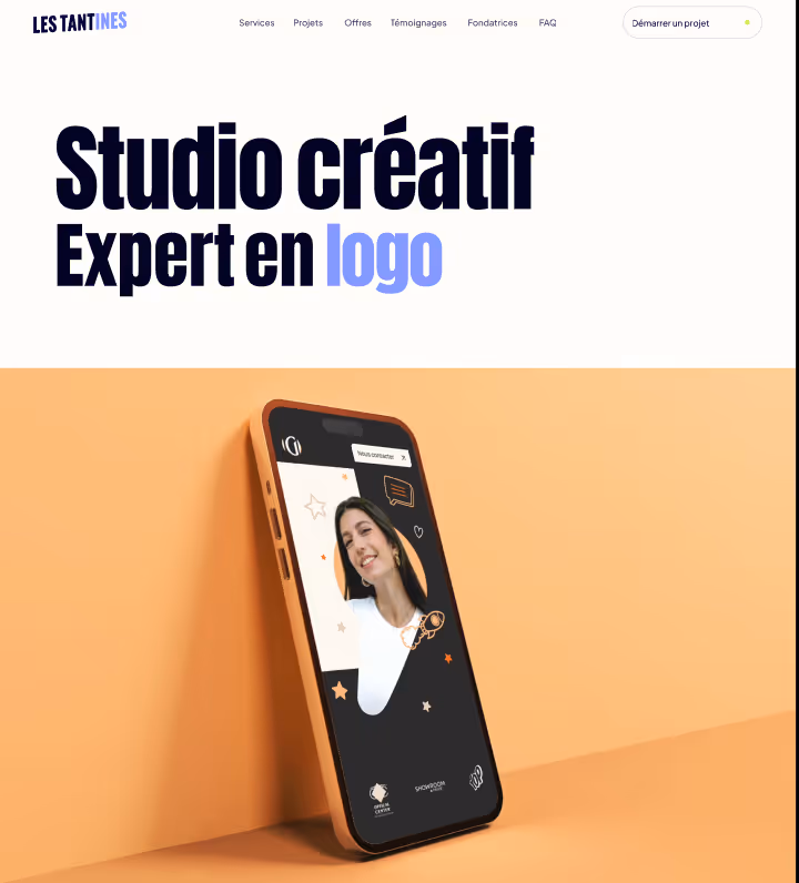 Website header for Les Tantines creative studio, showcasing a mobile phone with a smiling woman on the screen and text highlighting expertise in logo design.