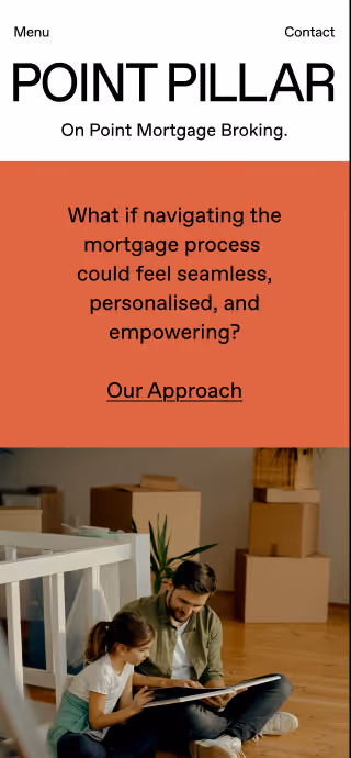 Father and daughter sitting on floor looking at a book together in a room with packed boxes.