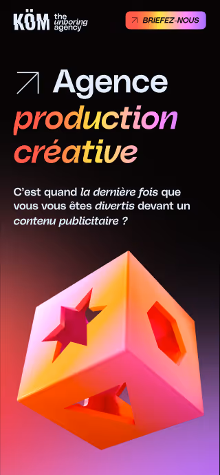Advertisement for KÖM creative production agency with colorful text and a glowing 3D cube displaying star and hexagon cutouts.