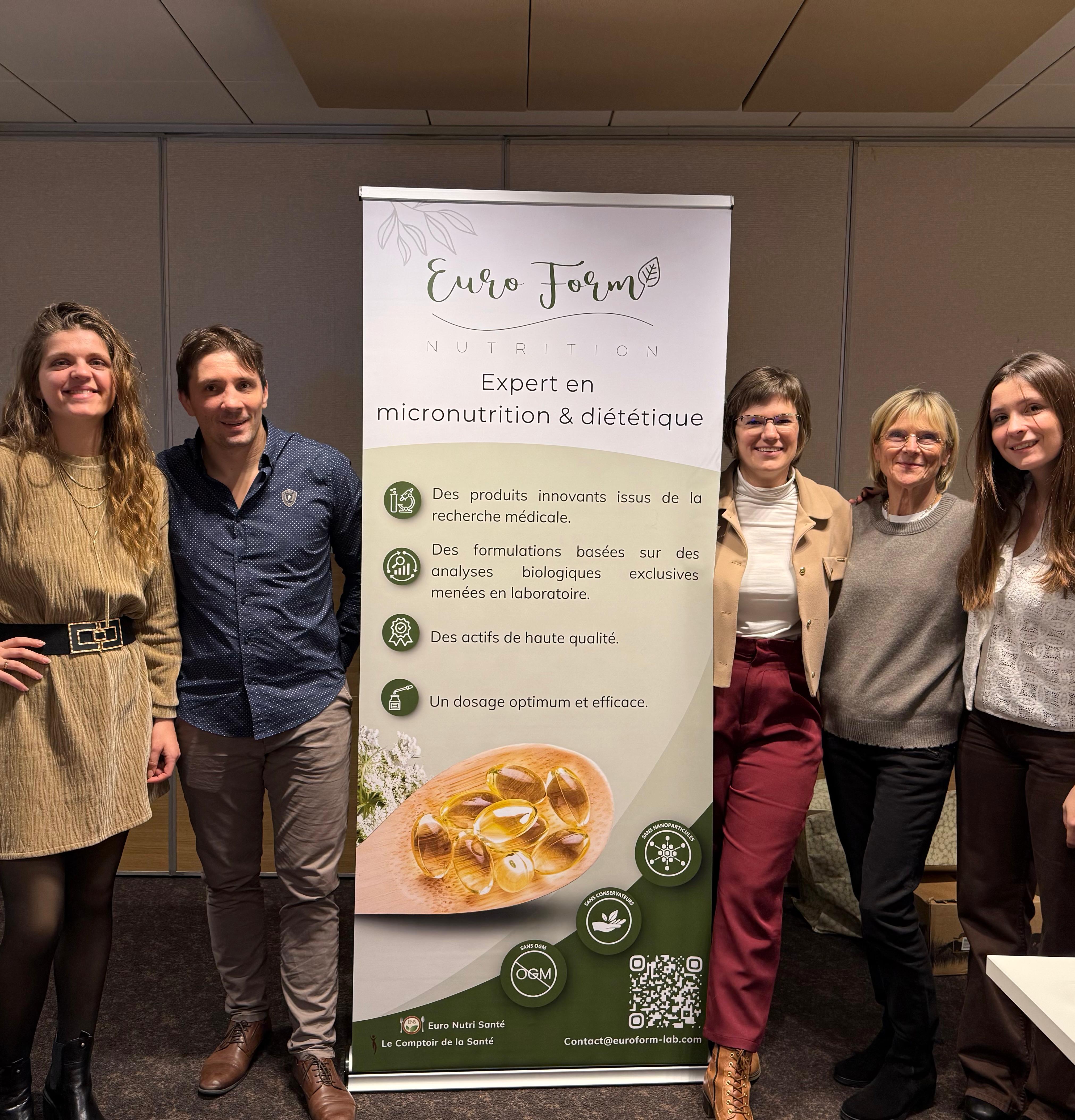 Five people standing around a nutrition product banner showing capsules and Euro Form branding.