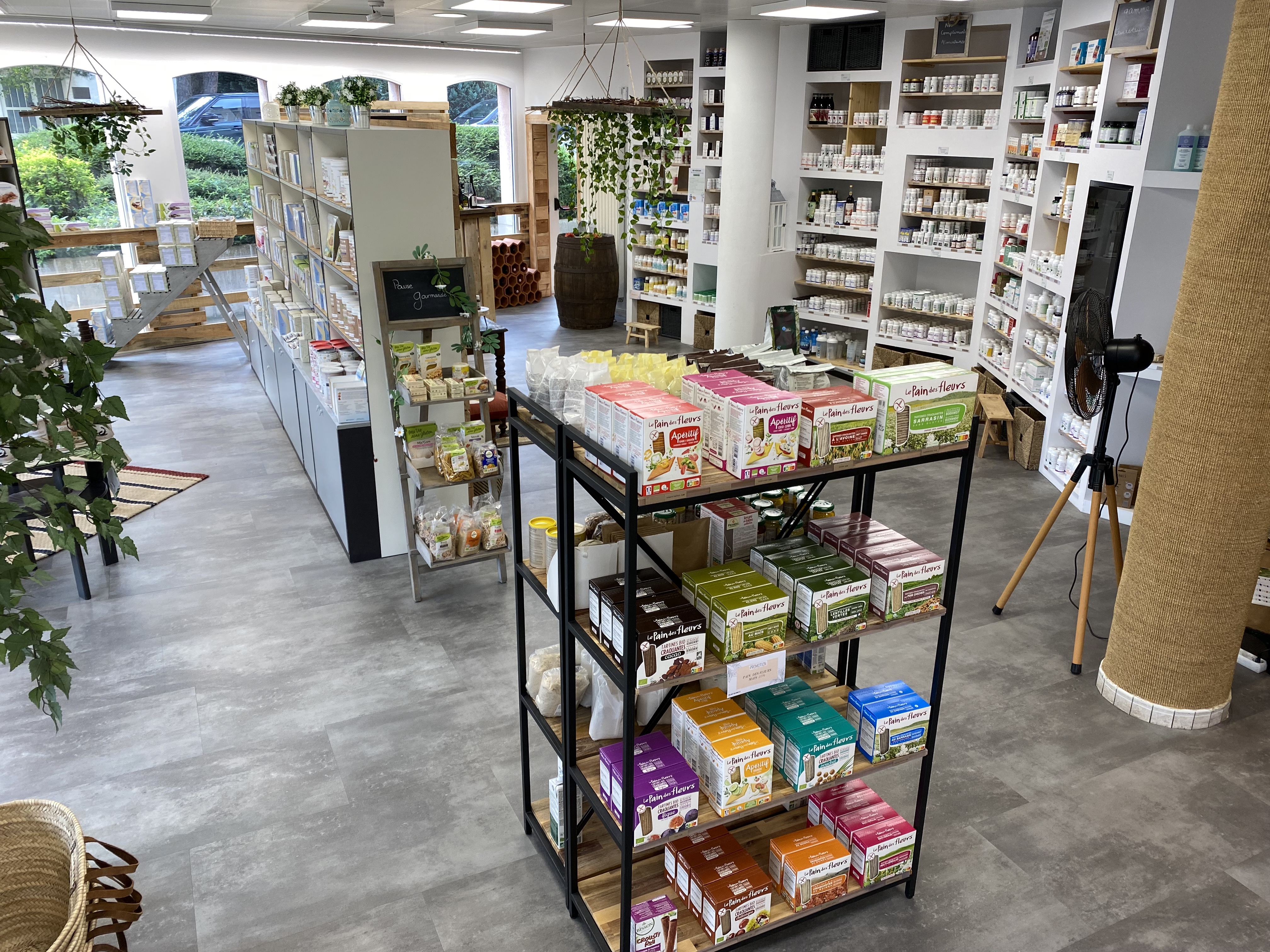 Interior of a clean store with shelves stocked with packaged food and health products.
