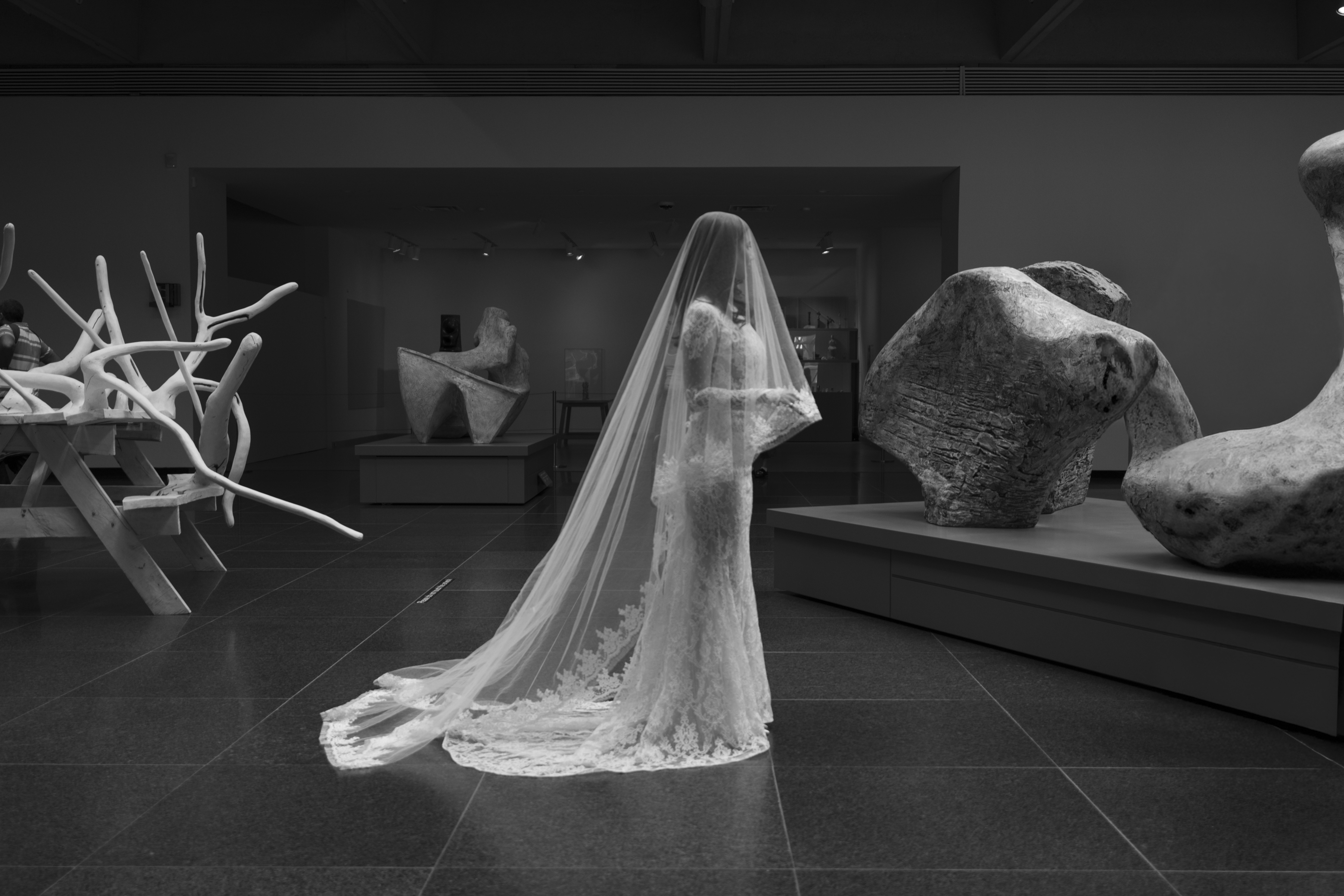 A bride standing in the Henry Moore gallery at the AGO