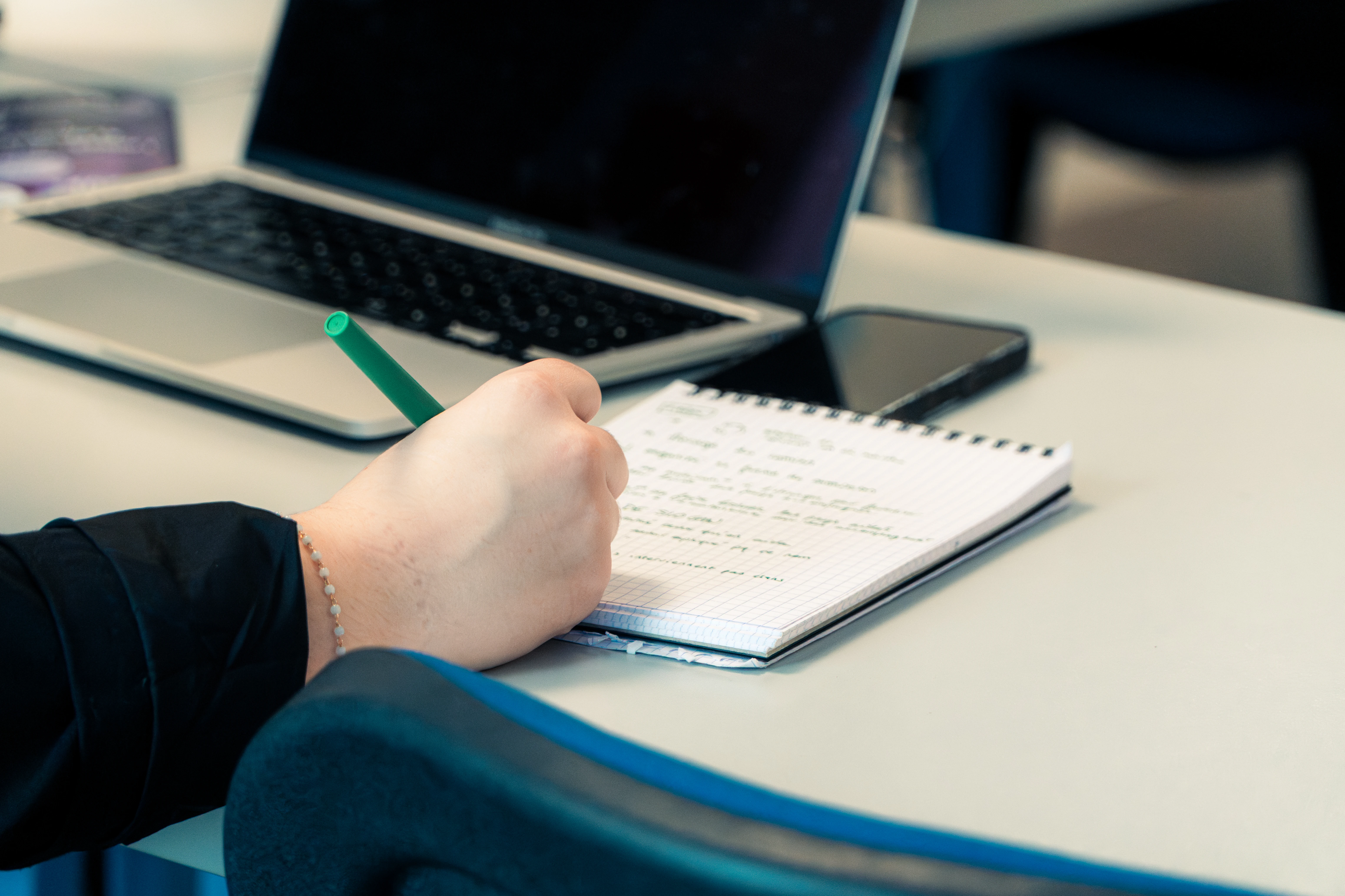 Ordinateur et carnet ouverts pendant un cours ISFAC