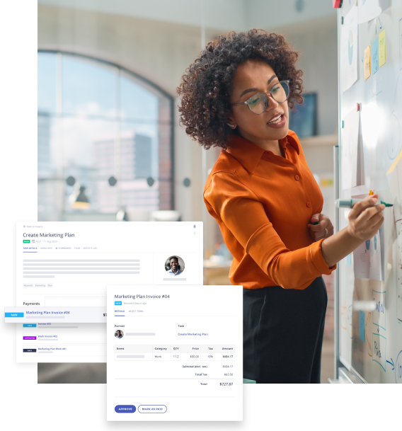 Professional woman in glasses and orange shirt writing on a whiteboard in an office with marketing plan and invoice documents displayed.