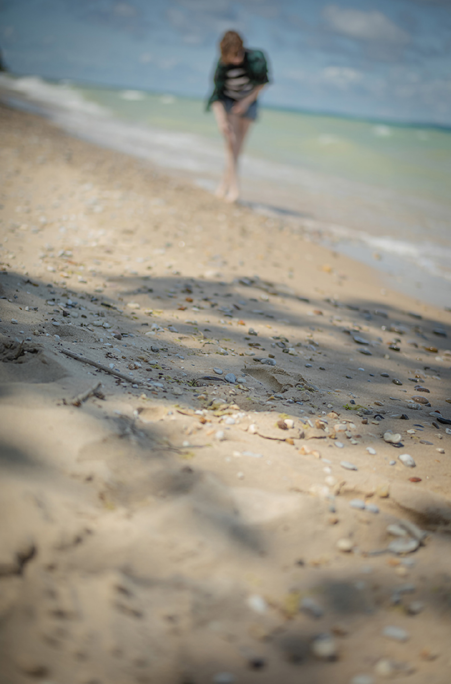 Jennifer Yaple student interpretation: a figure walks the shoreline at Tusen Takk looking for shells