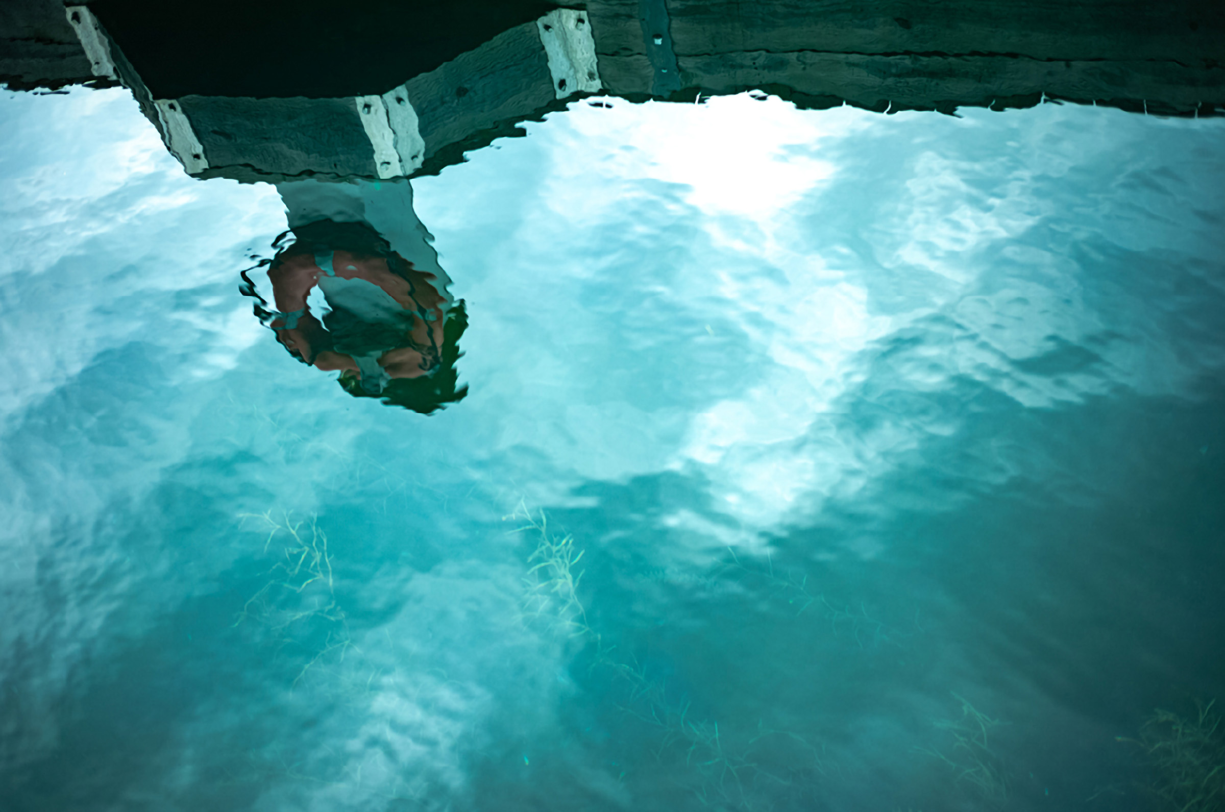 Jennifer Yaple student interpretation of Rinko Kawauchi: a reflection of a life preserver cast onto clear turquoise water at Suttons Bay, viewed from above