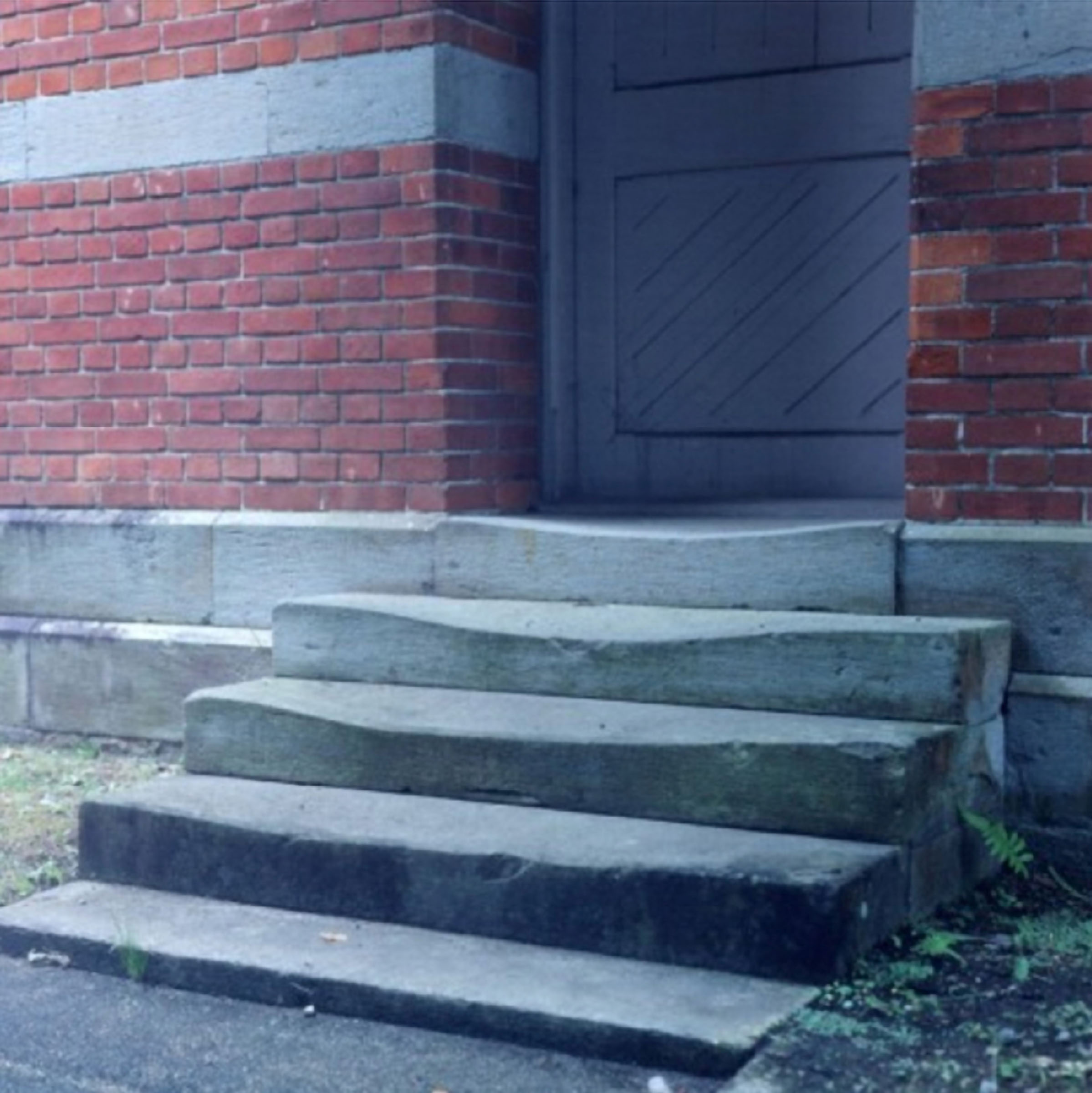 Rinko Kawauchi reference image: concrete steps rise toward a weathered brick building
