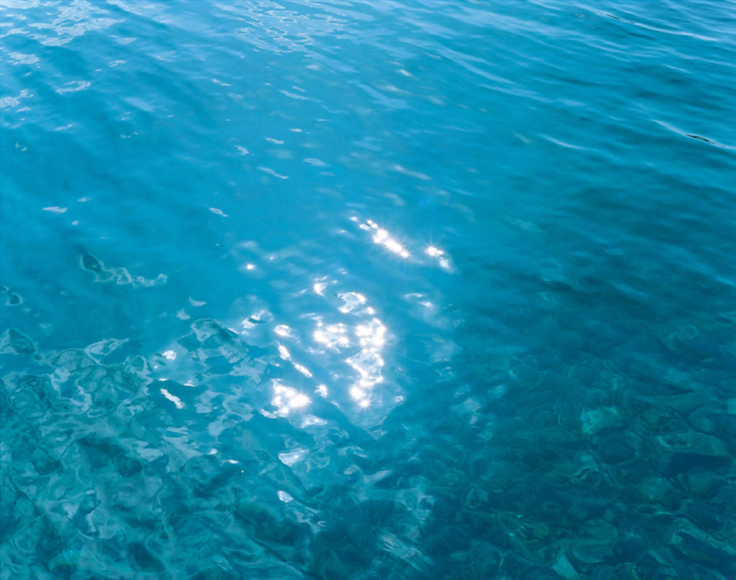 Rinko Kawauchi reference image: deep turquoise water shot from above with sunlight fracturing across the surface