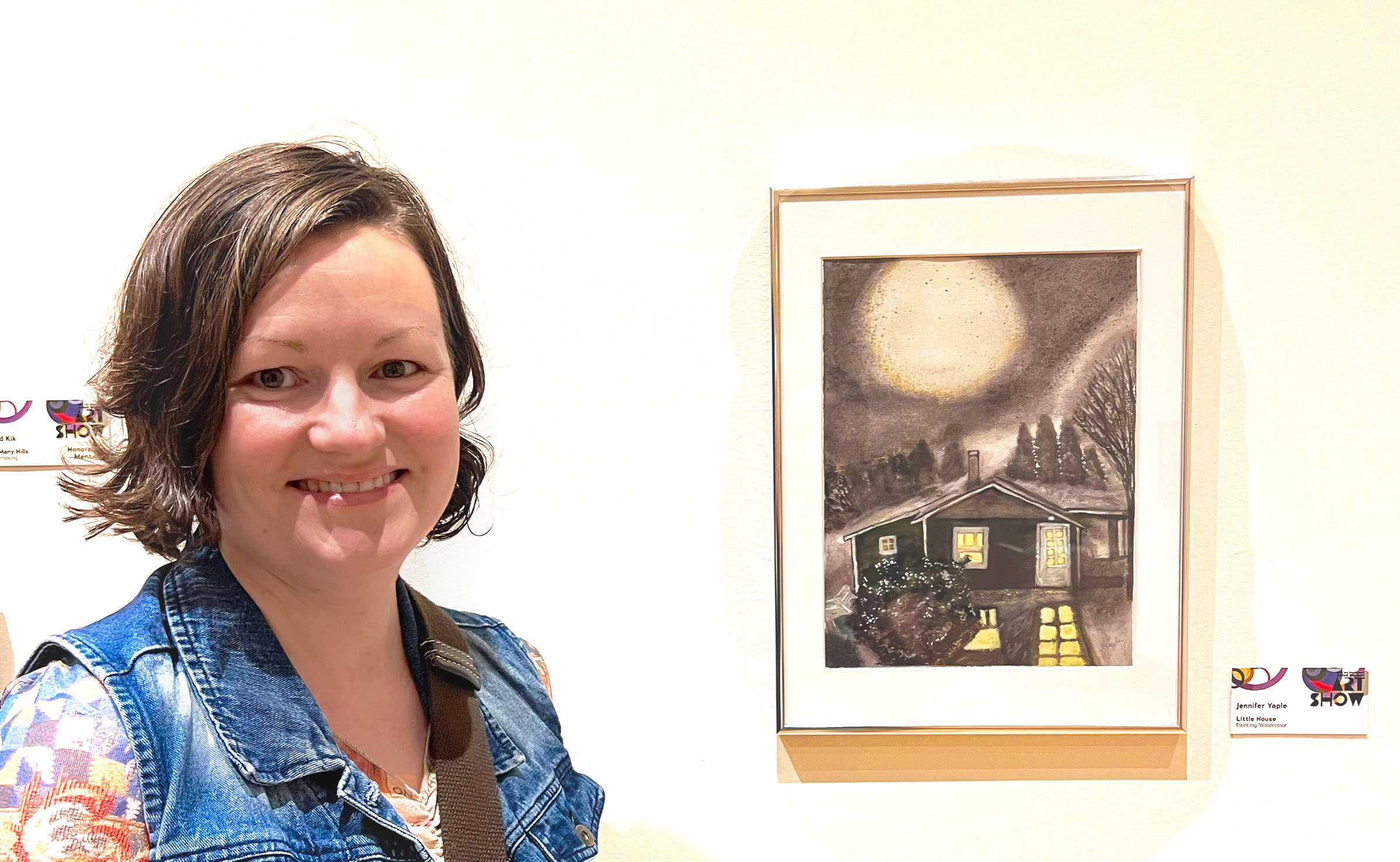 Jennifer Yaple standing beside After Dark at the Dennos Museum Juried Student Art Show.