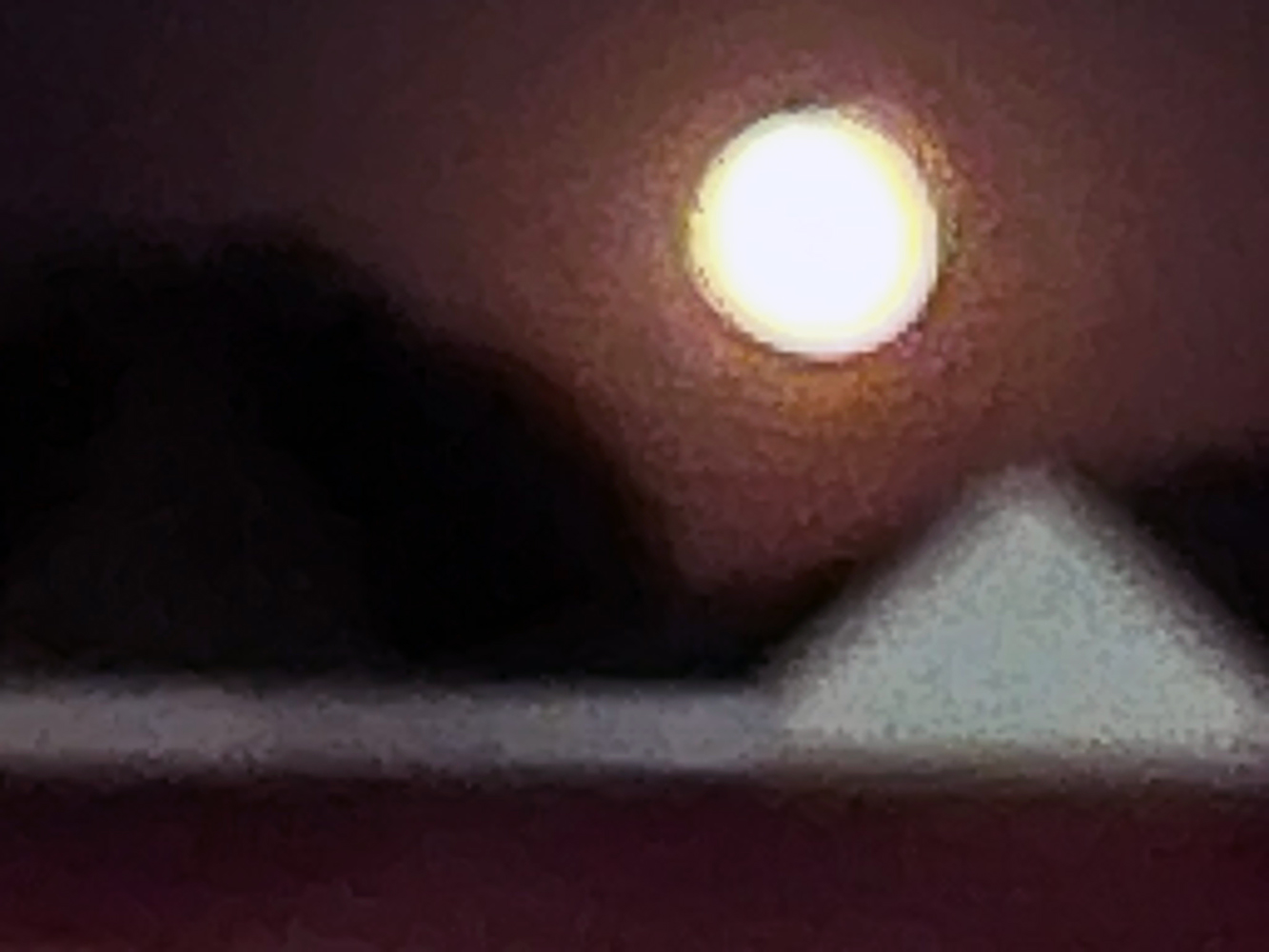 Blurred moon photograph taken through the window of a moving car after Fourth of July fireworks.