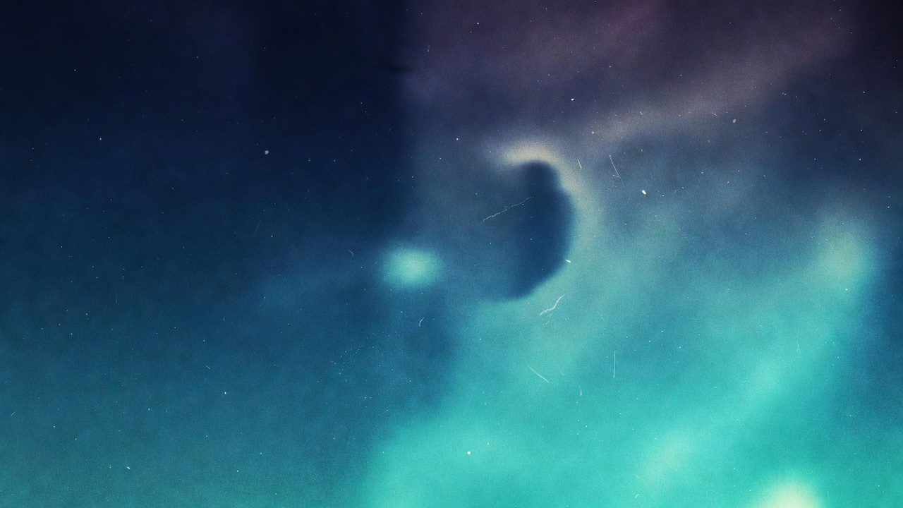 Abstract close-up of a blue and black gradient with soft horizontal streaks on a blue background.