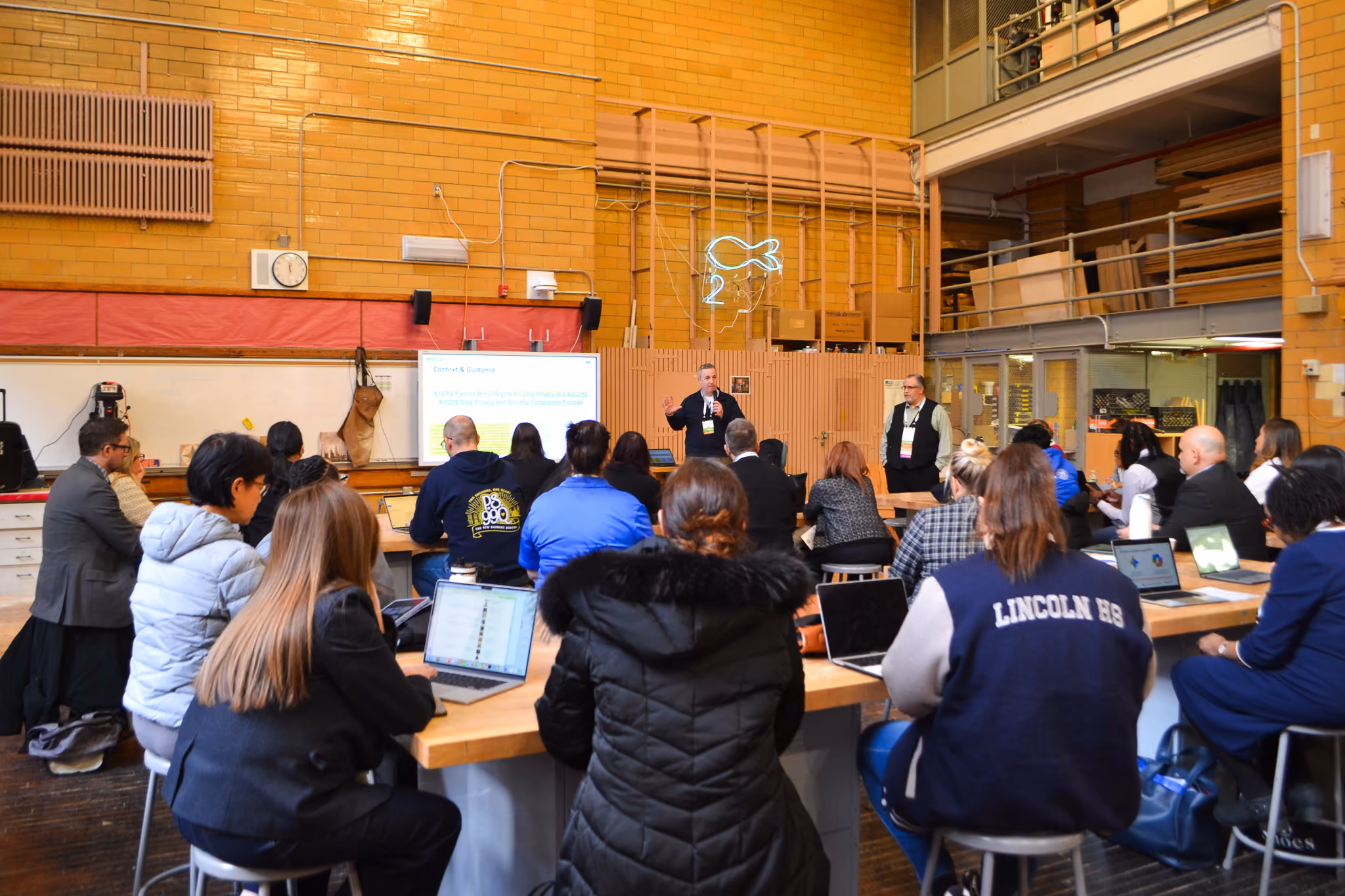Presenter speaking to staff at a Lincoln High School professional development session