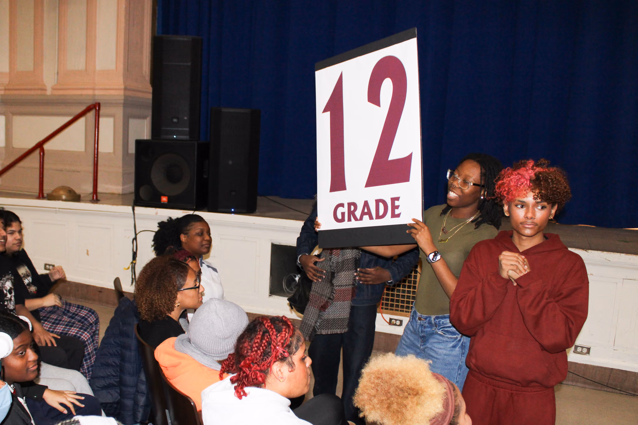 Students holding a Grade 12 sign at a school assembly