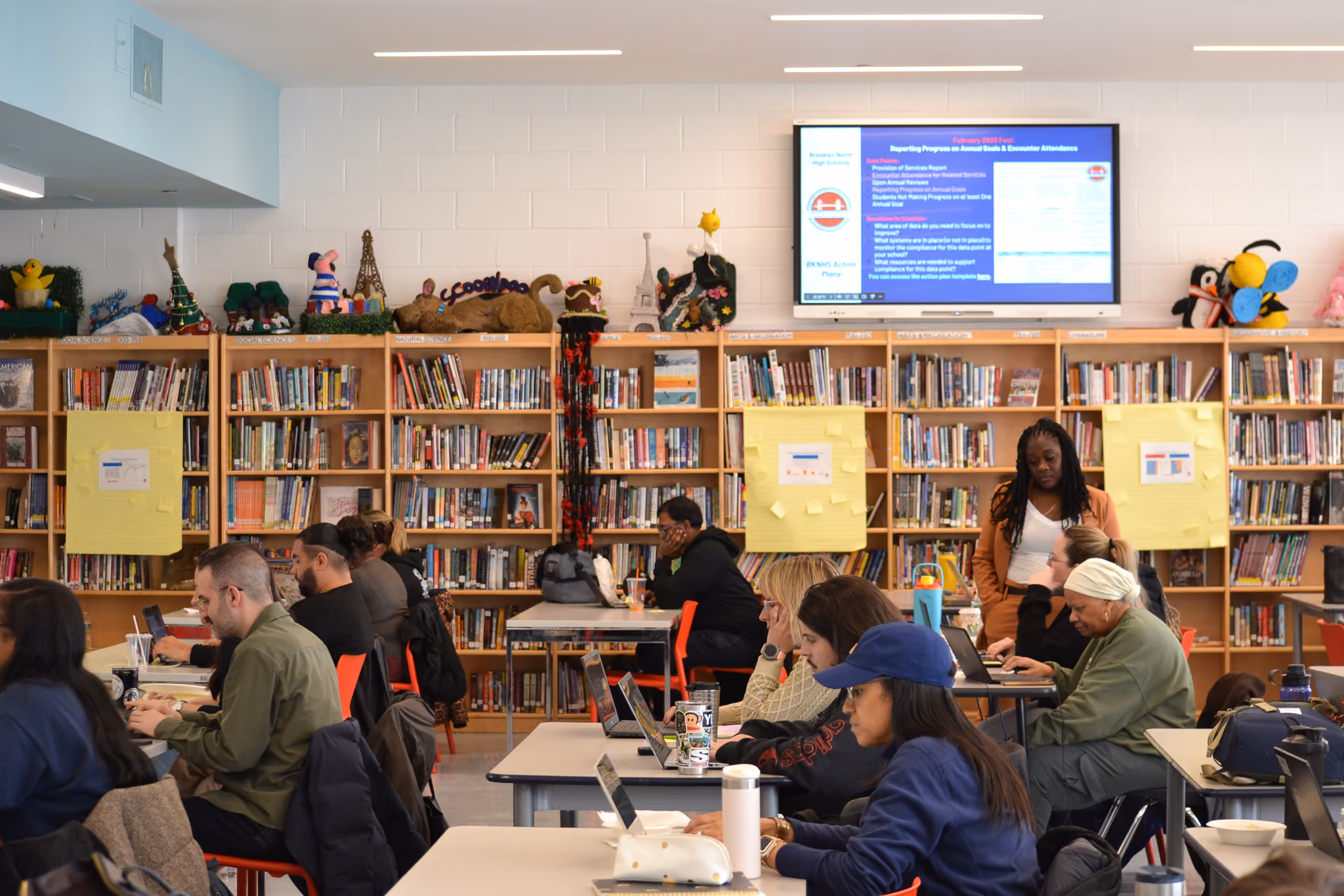 Staff members working on laptops during a professional development session in school library