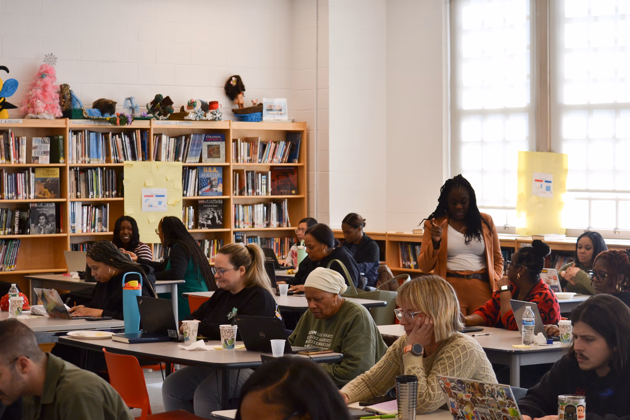 Teachers and staff attending a professional development session in school library