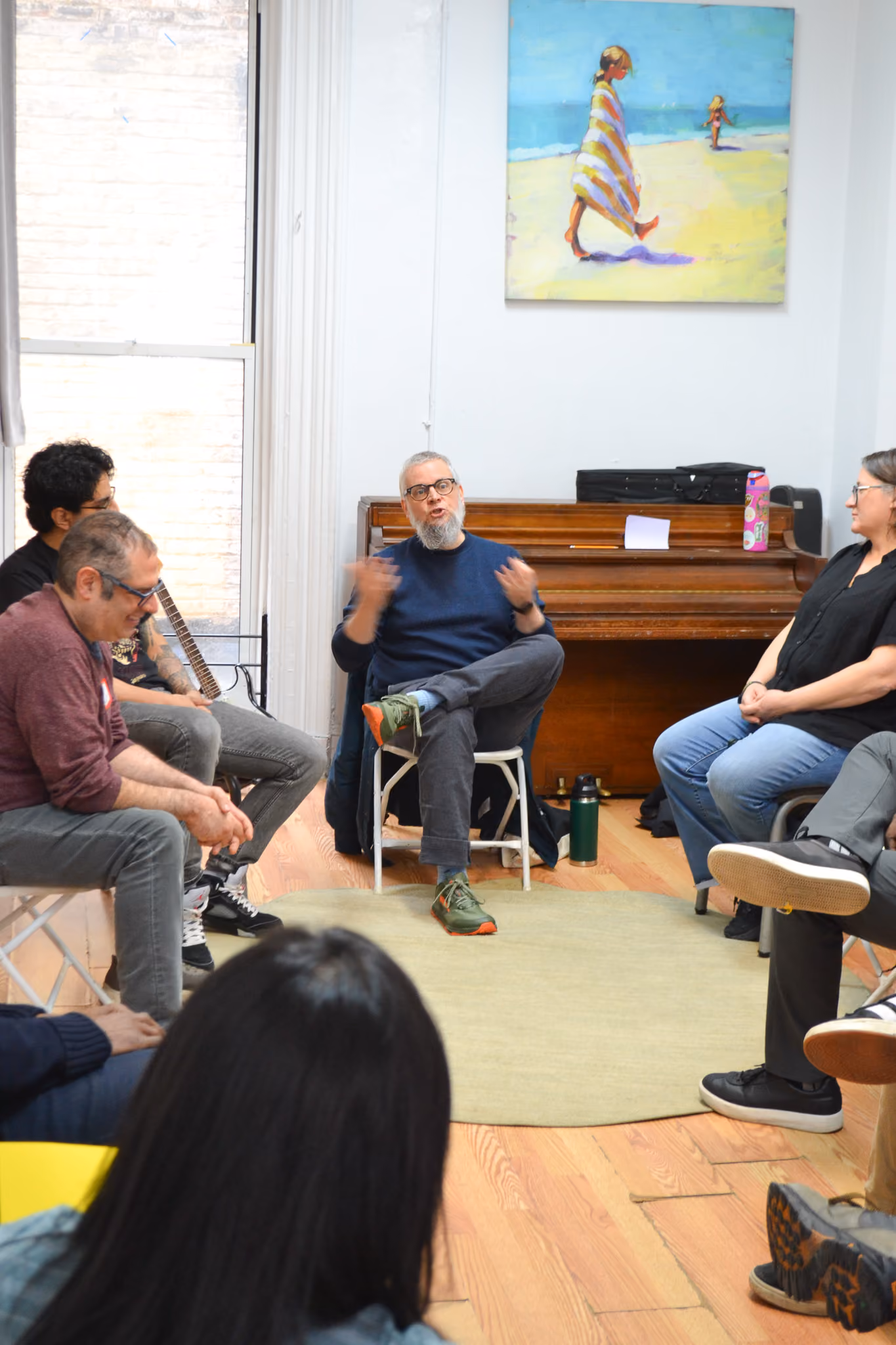 Instructor speaking to a small group seated in a circle
