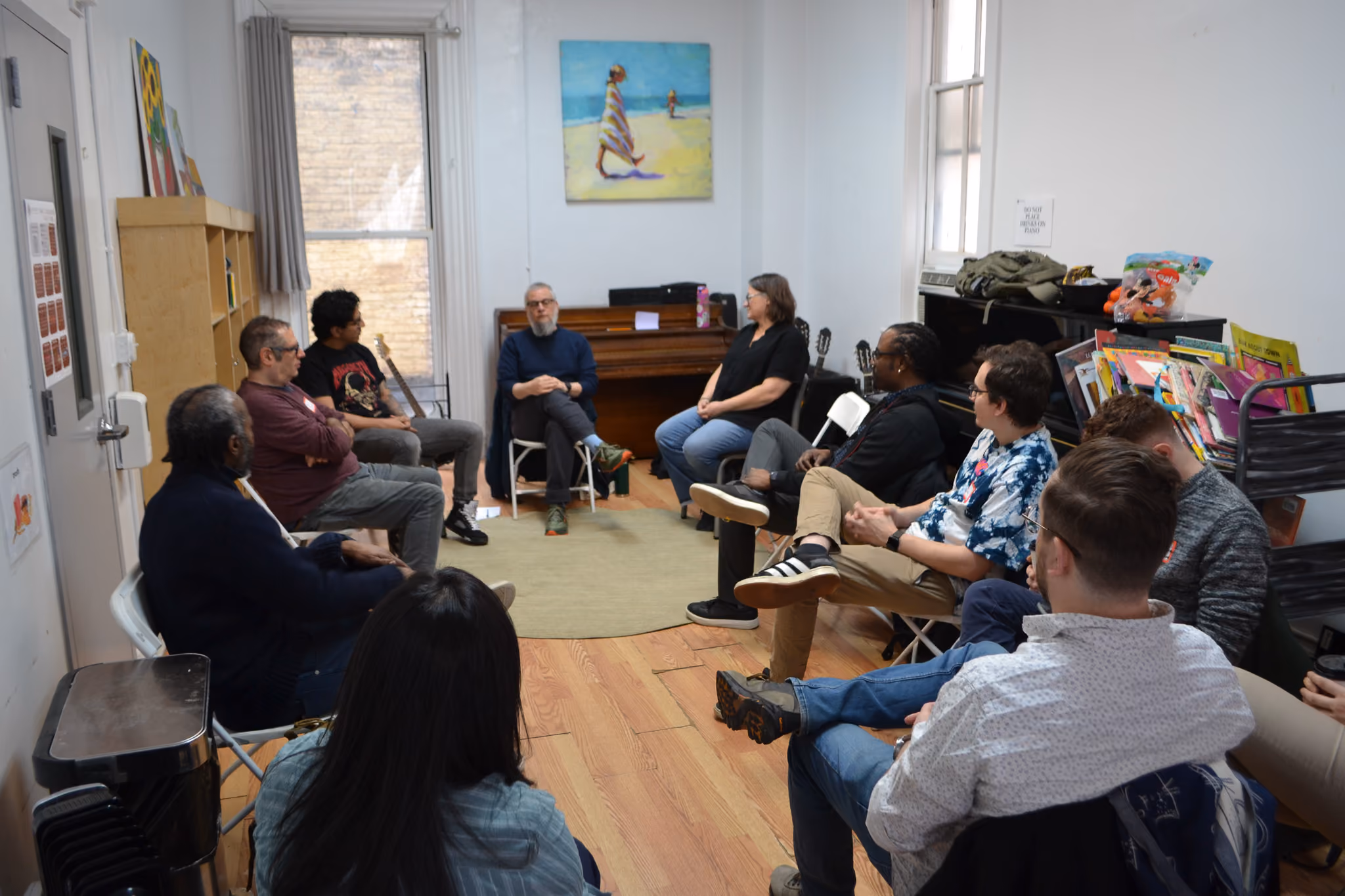 Students and adults seated in a circle during a classroom discussion