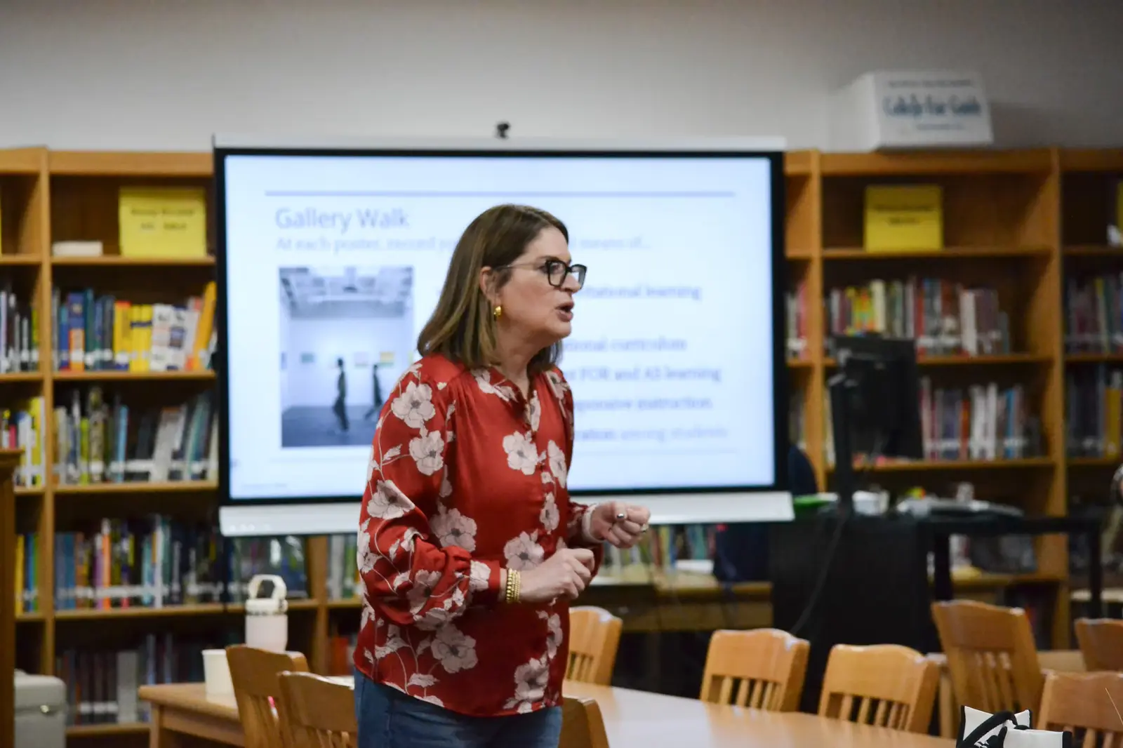 Teacher presenting Gallery Walk lesson in school library