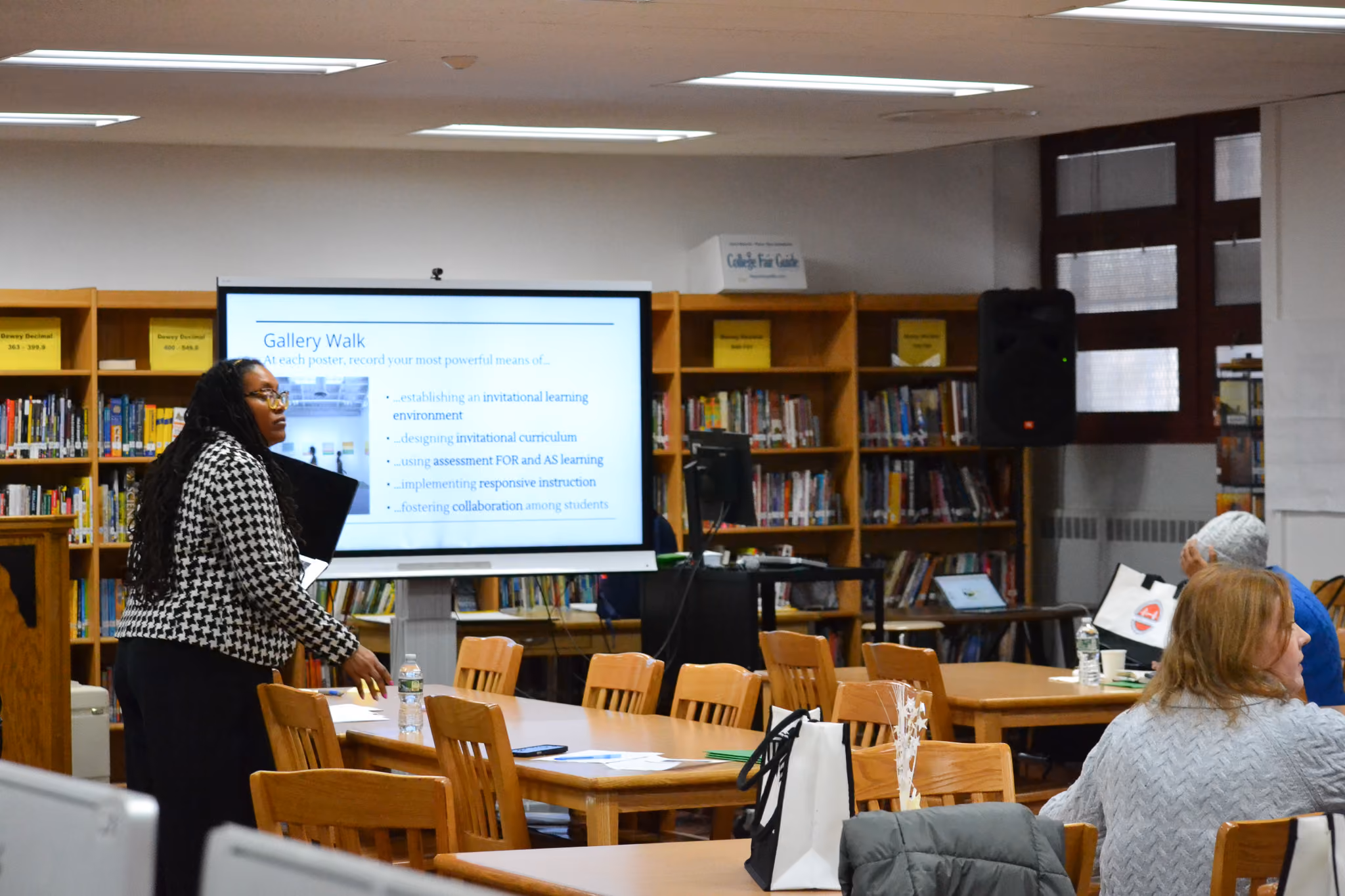 Teacher presenting a Gallery Walk slide in school library