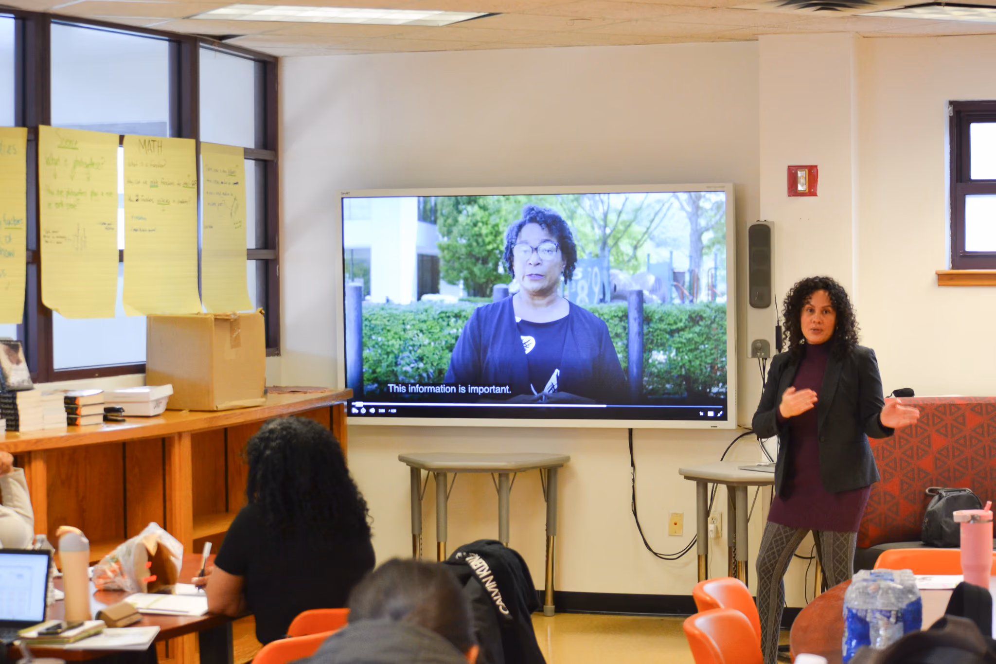 Teacher presenting a video to students in a classroom