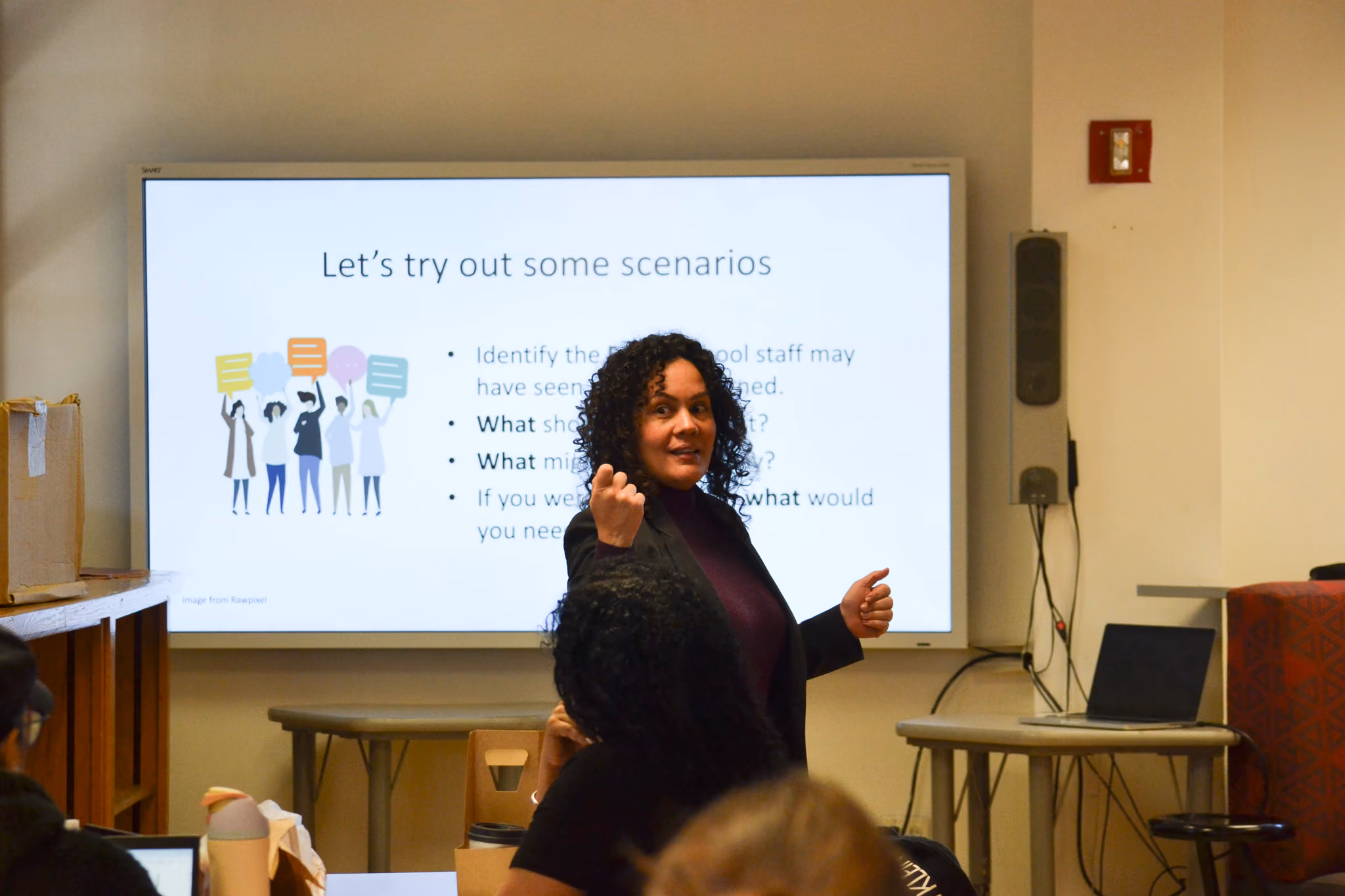 Presenter leading a scenario-based staff training session in classroom