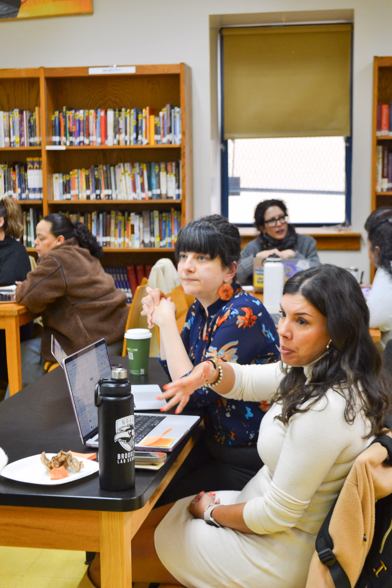 Teachers gathered in school library during professional development meeting