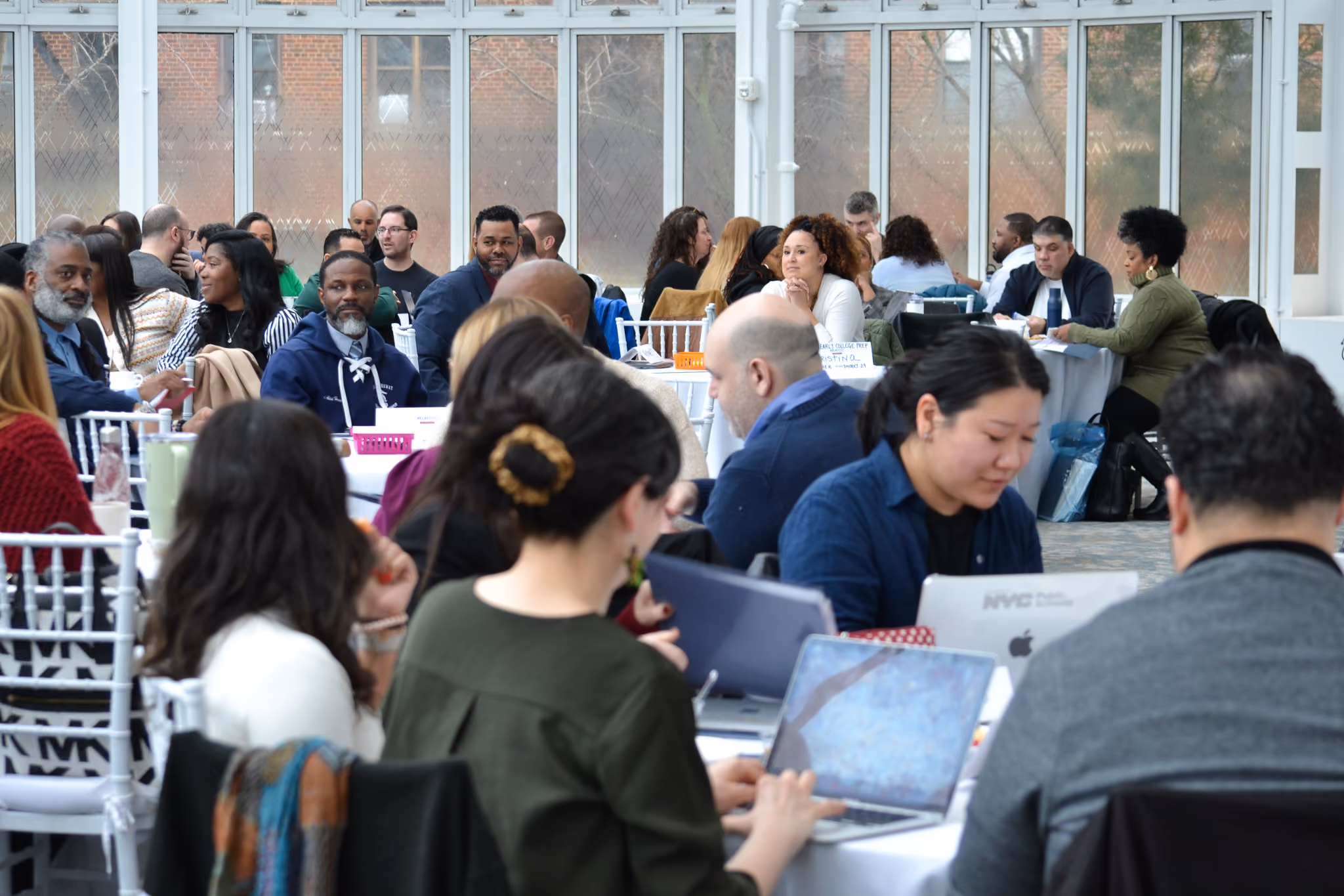 Educators and staff collaborating at tables during a professional conference
