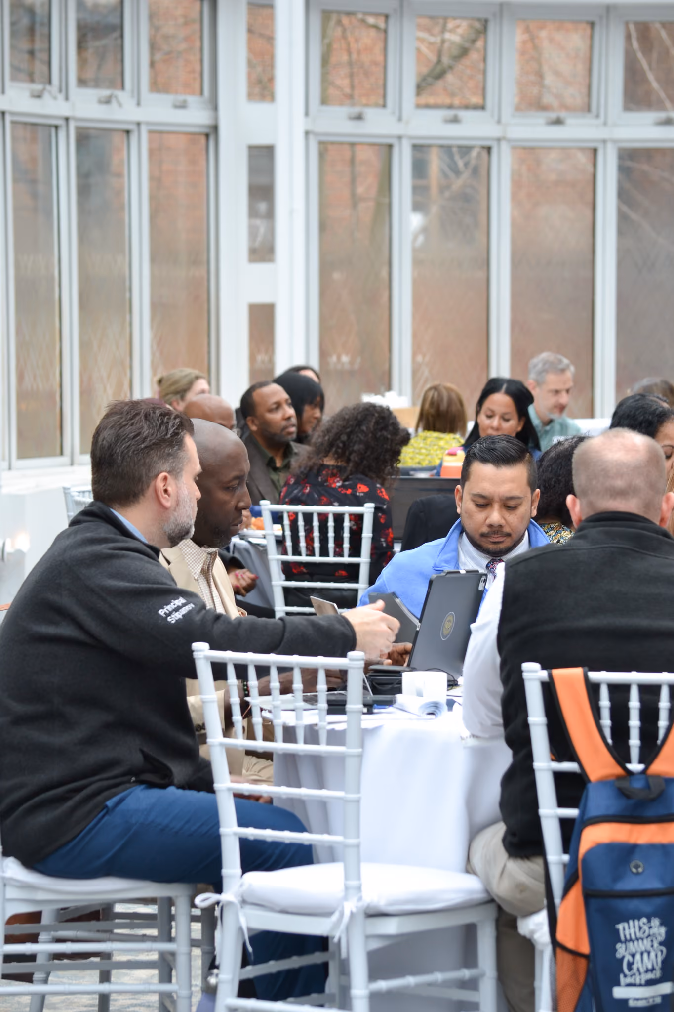 Educators and staff networking at an indoor school event
