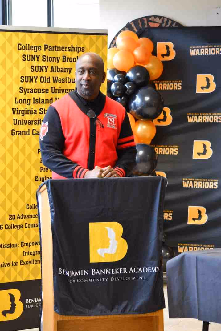 Speaker at Benjamin Banneker Academy podium during college partnership event