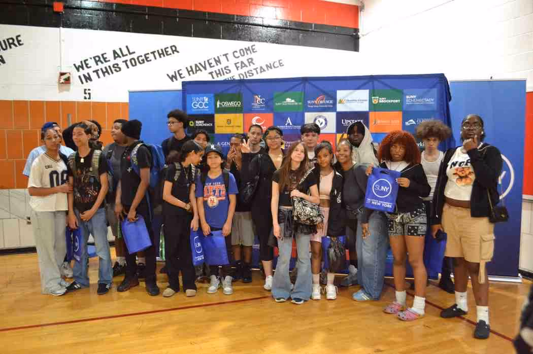 Students posing at SUNY college fair in school gymnasium