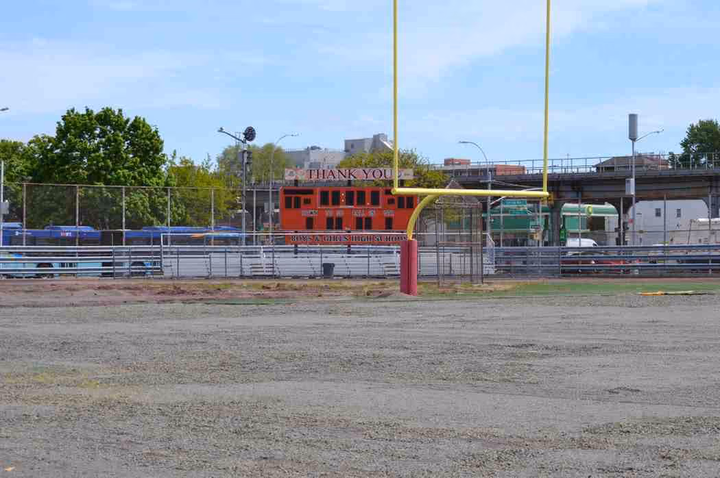 School football field with goal post and scoreboard under construction