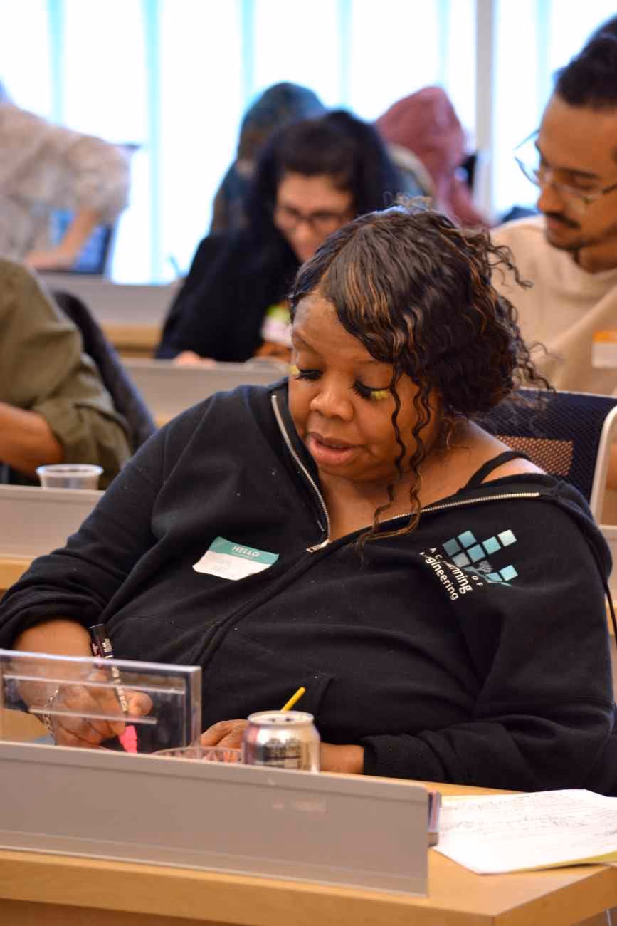 Adult participant reviewing notes during a professional development session