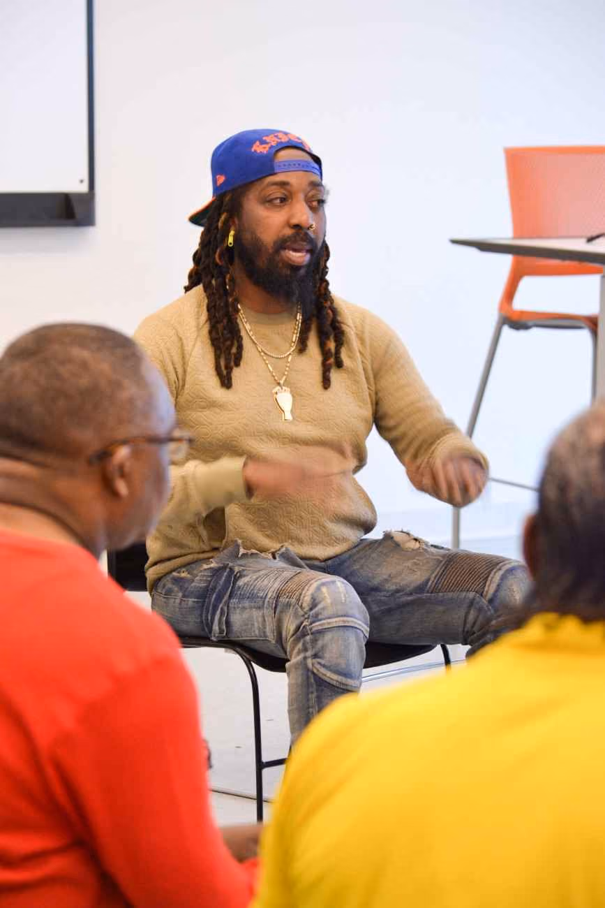 Guest speaker addressing a small group during a classroom session