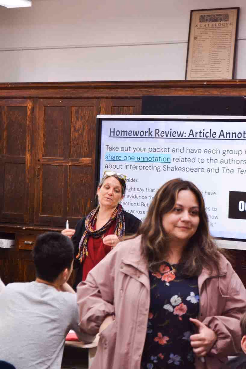 Teacher leads homework review lesson on article annotation with students