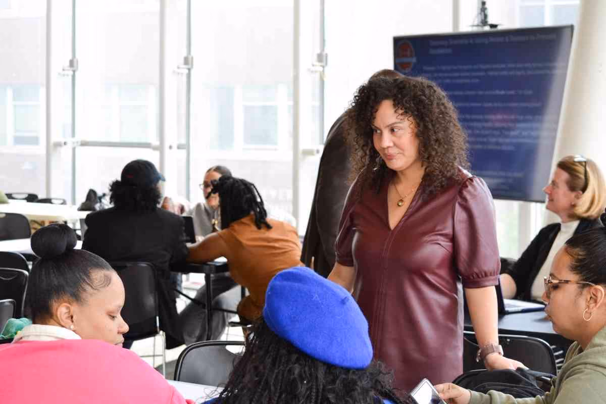 Facilitator speaking with attendees at a school counselor workshop event