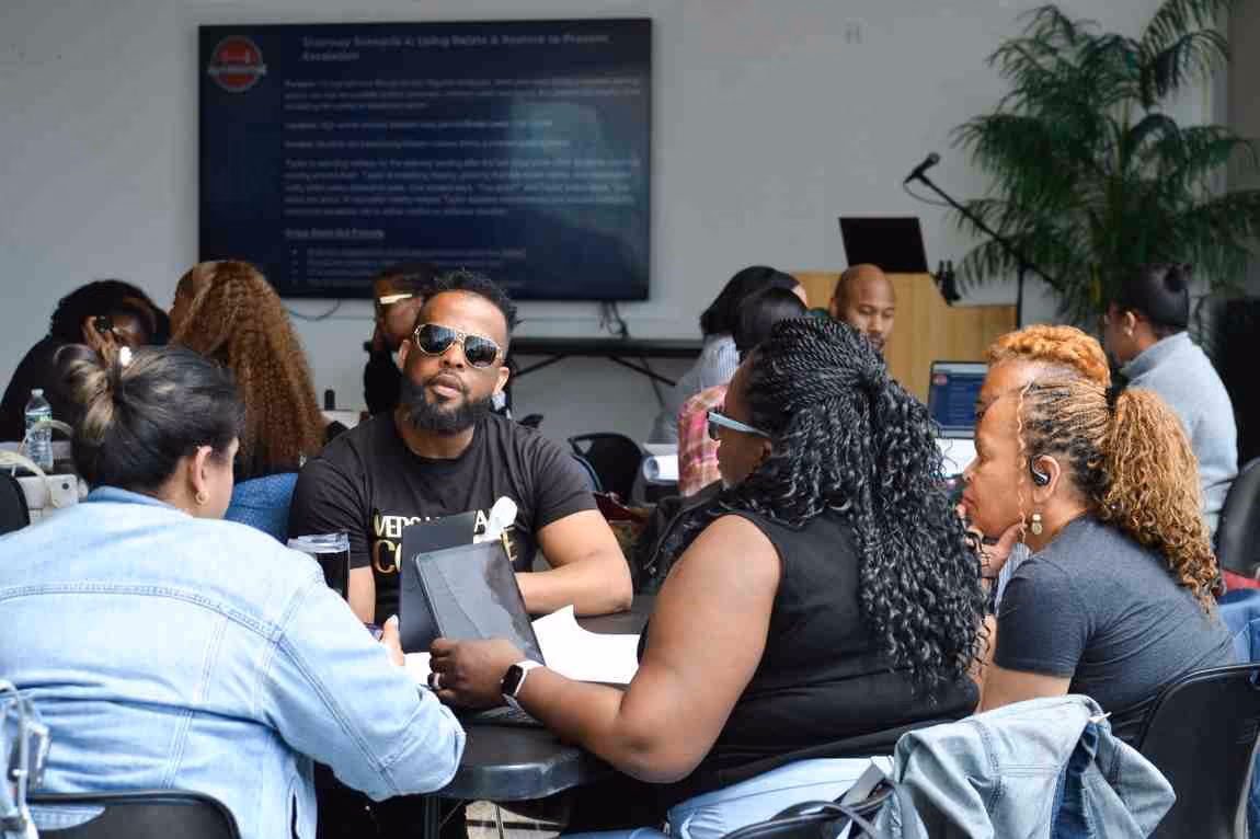 Educators collaborating at tables during a professional development workshop
