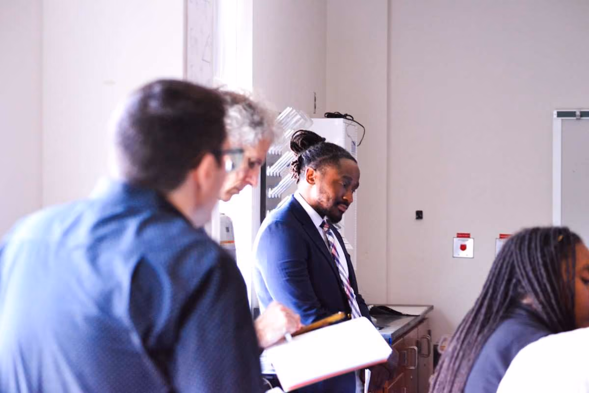 Adults in professional attire reviewing notes during a school meeting