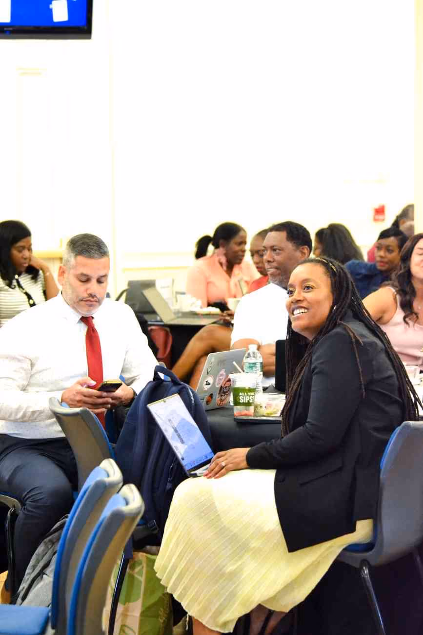 Educators smiling and engaging during a professional development meeting