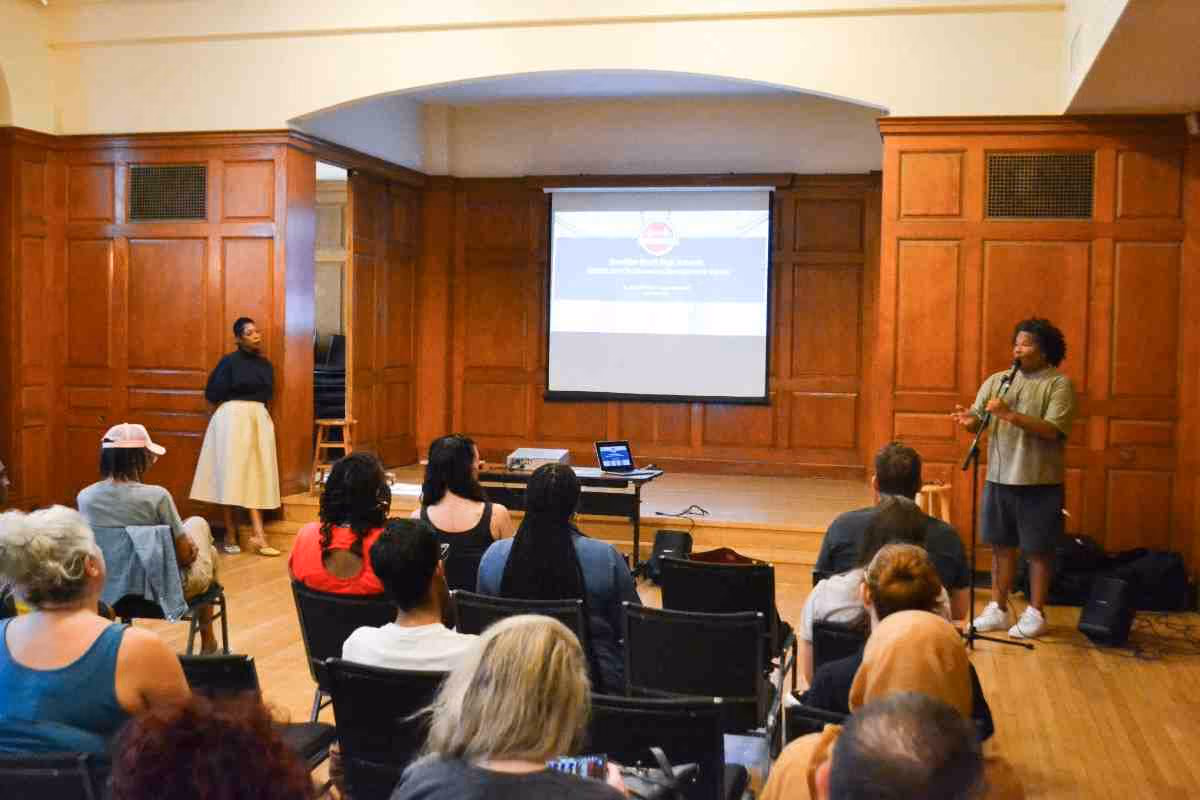 Presenter speaks to seated audience during a school arts professional development session