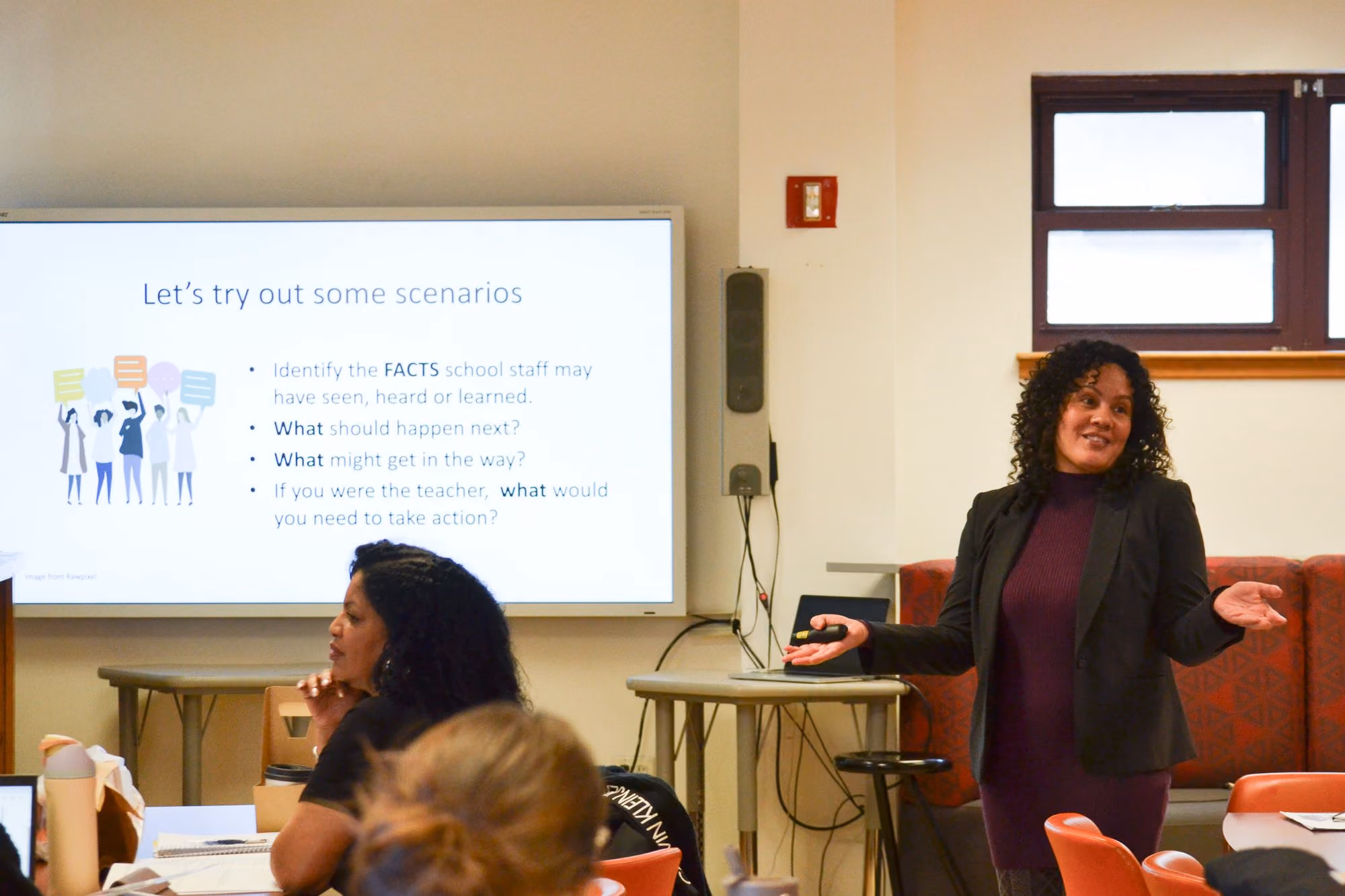 Teacher leading a professional development workshop on school scenarios