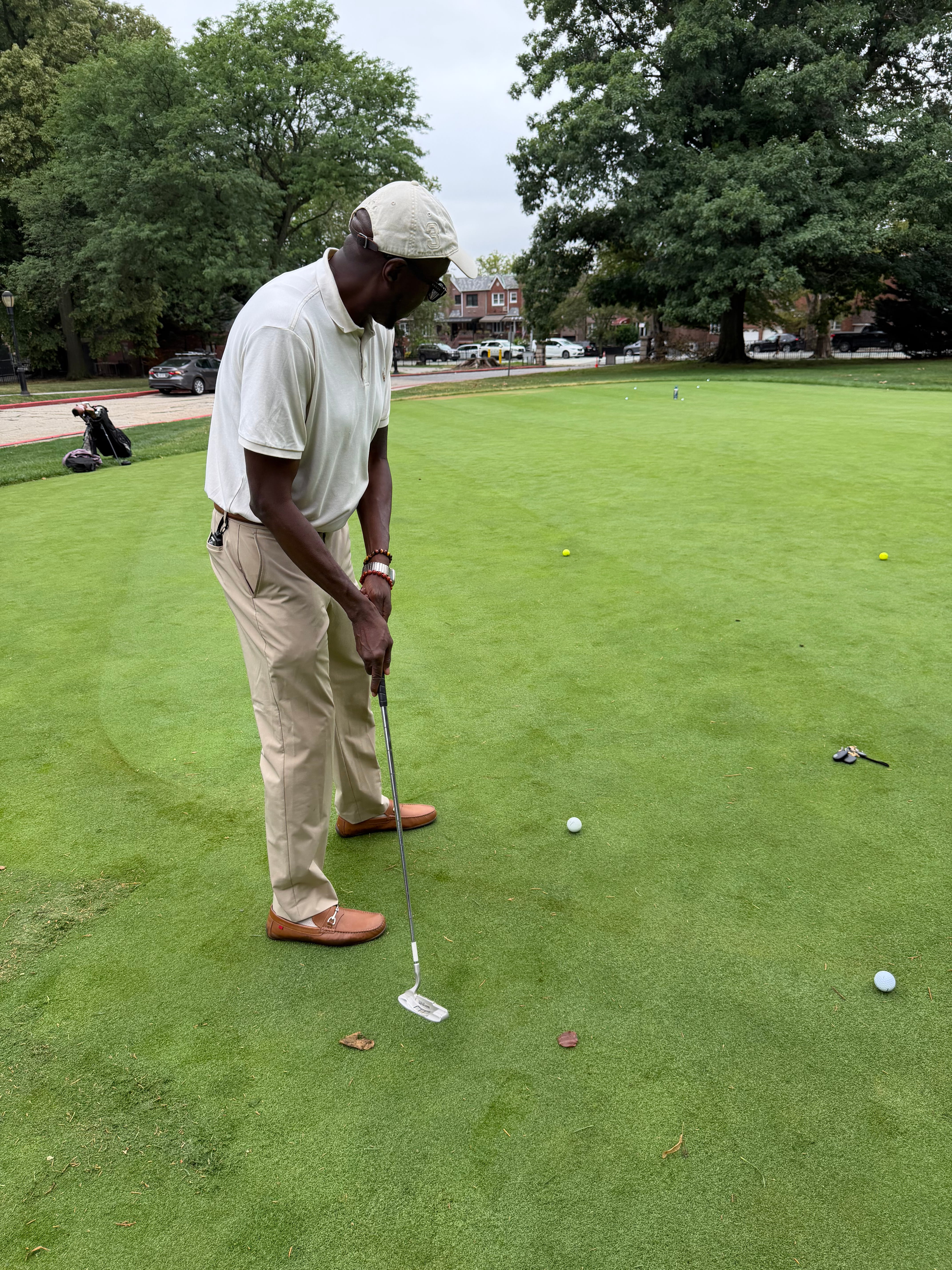 Golfer putting on a green during a school golf event