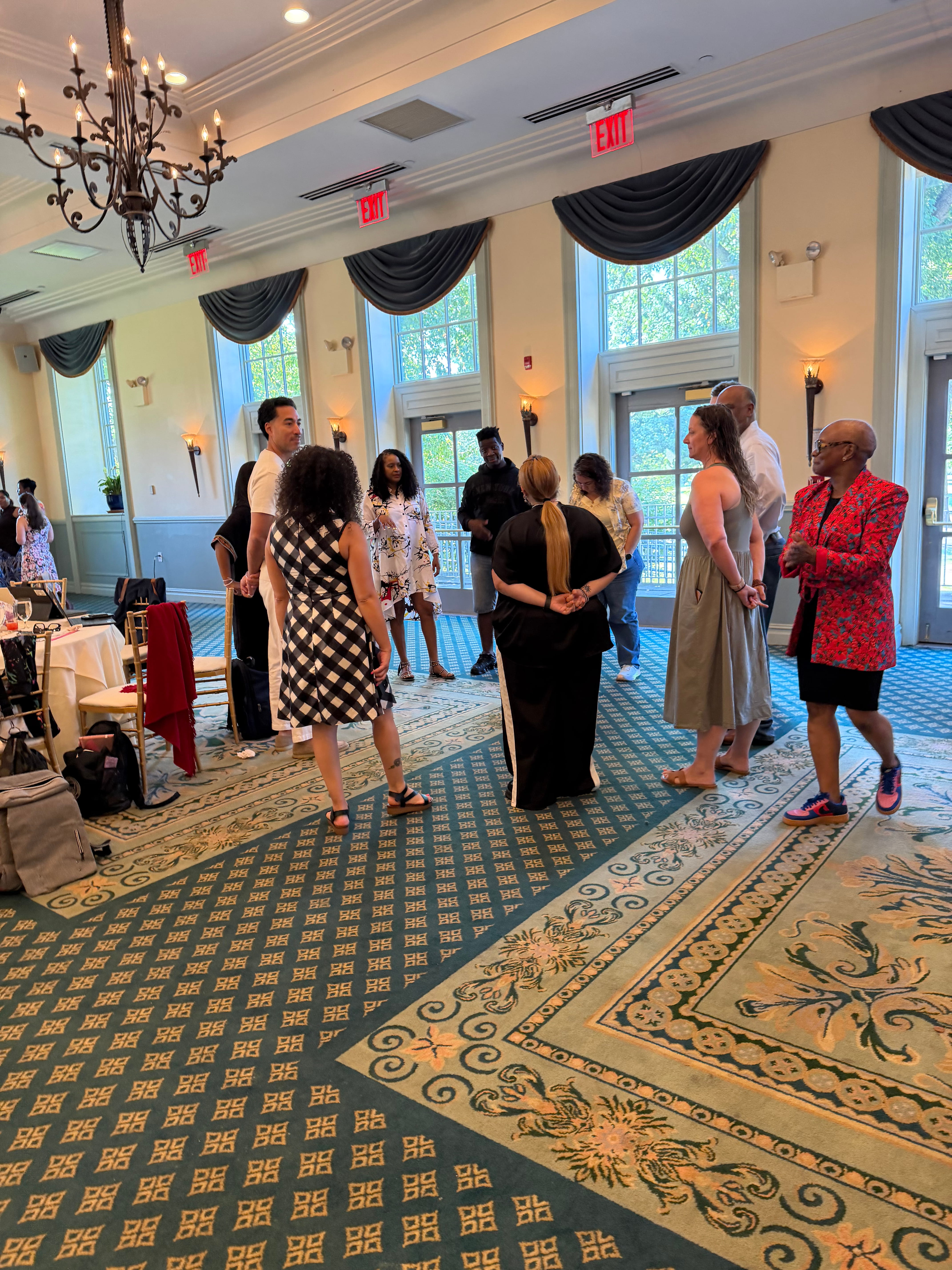 Attendees networking in an elegant ballroom at a school event