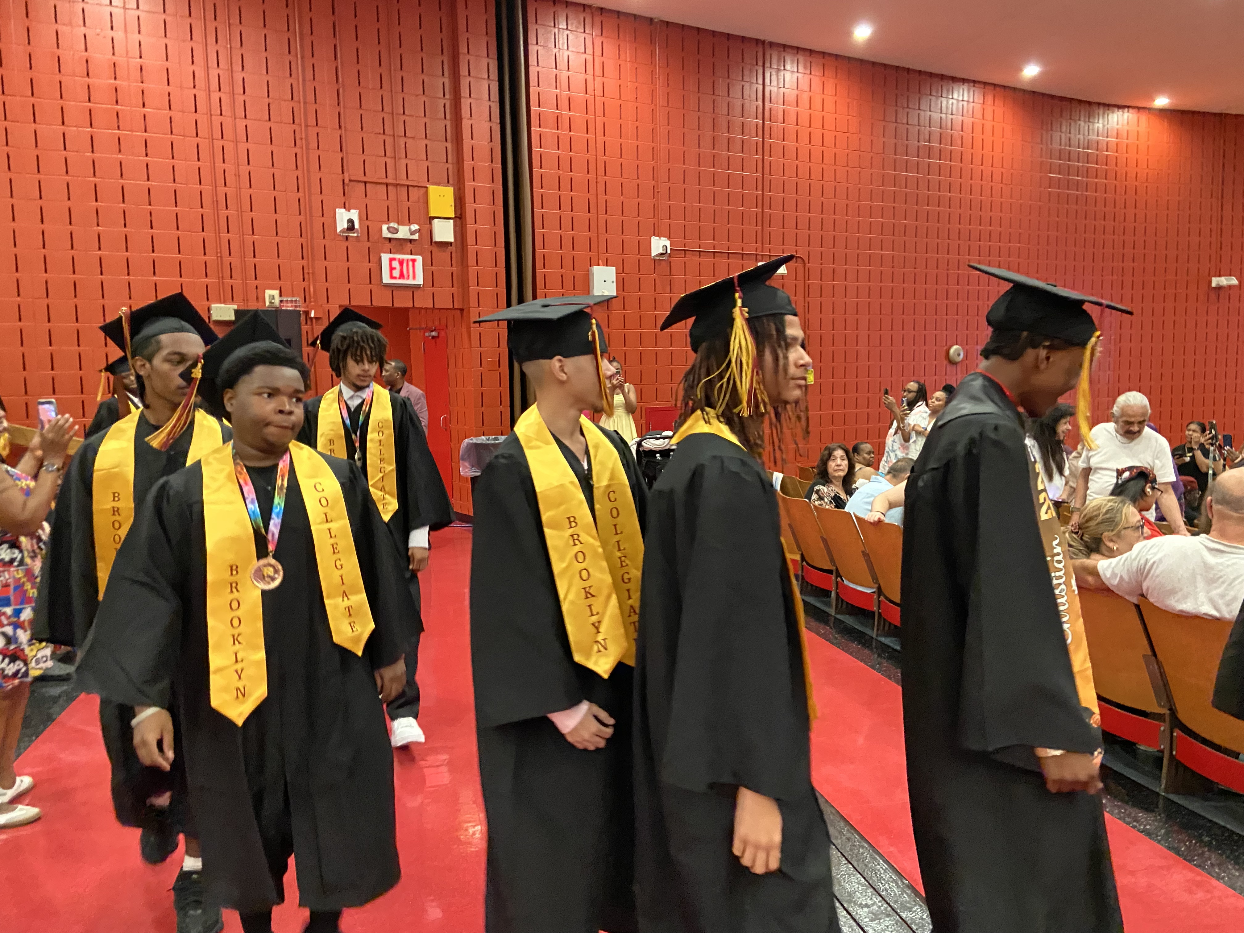 Brooklyn Collegiate graduates processing in cap and gown during commencement ceremony