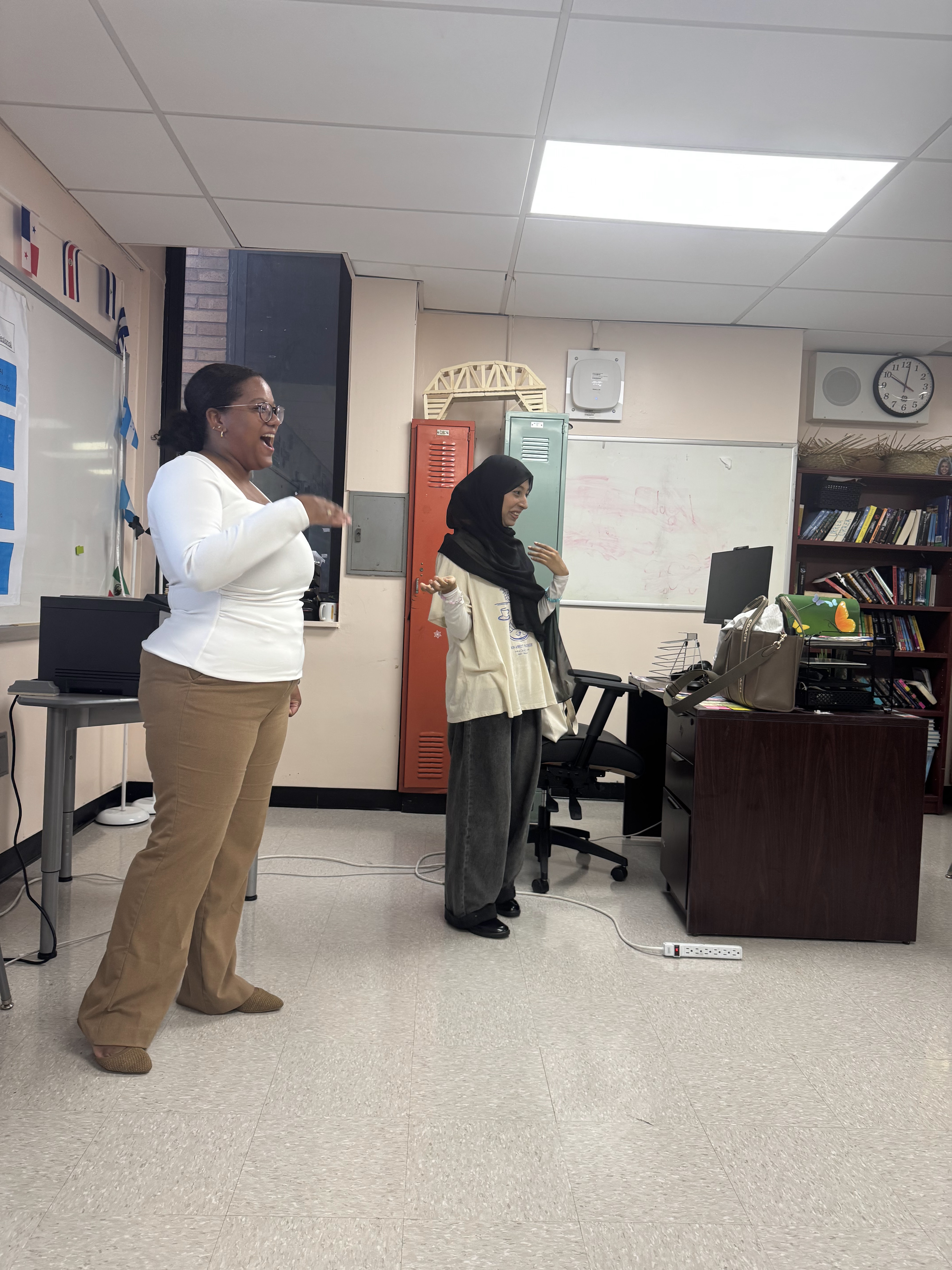 Teacher and student talking and gesturing in a classroom