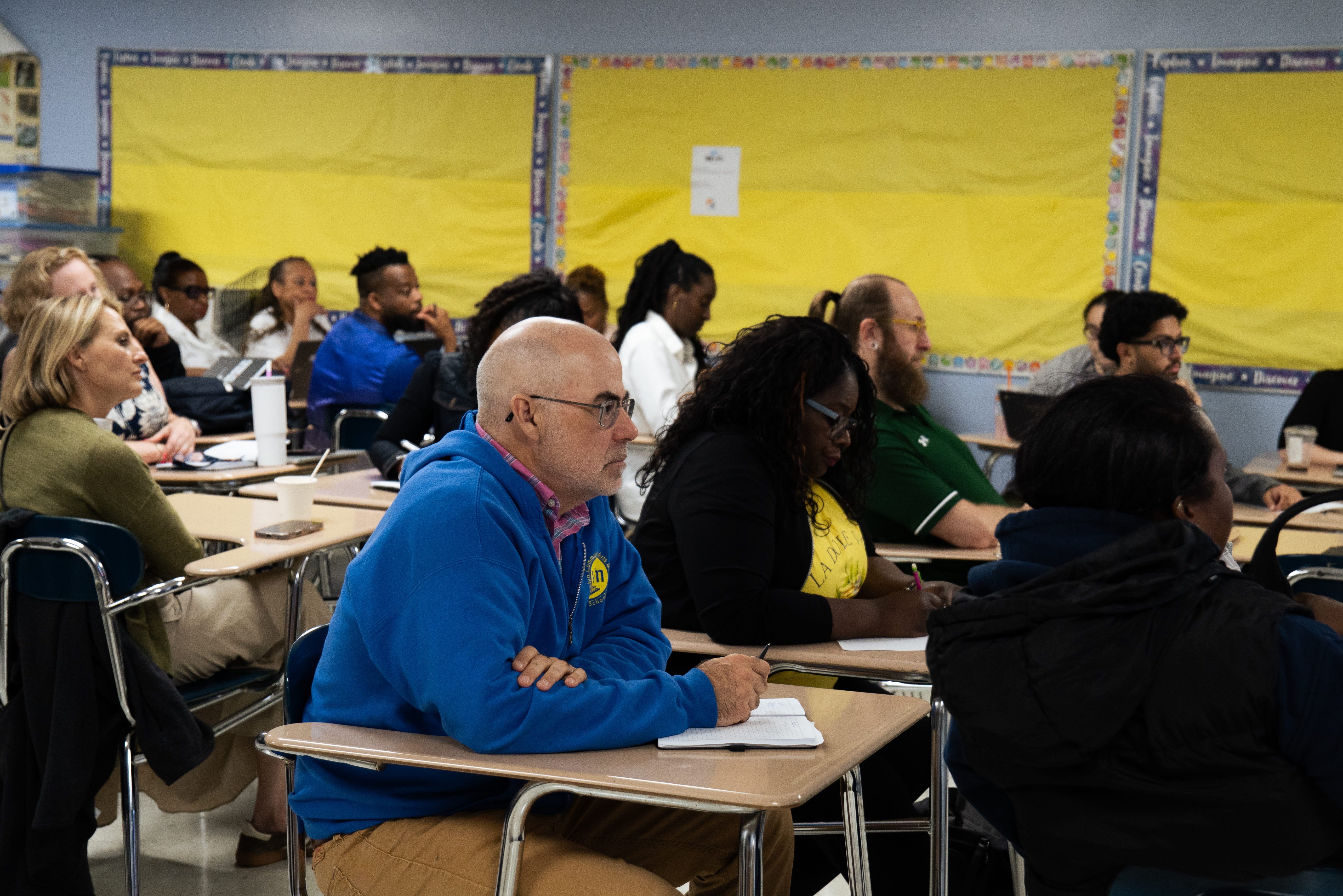 Adults attending a professional development session in a classroom