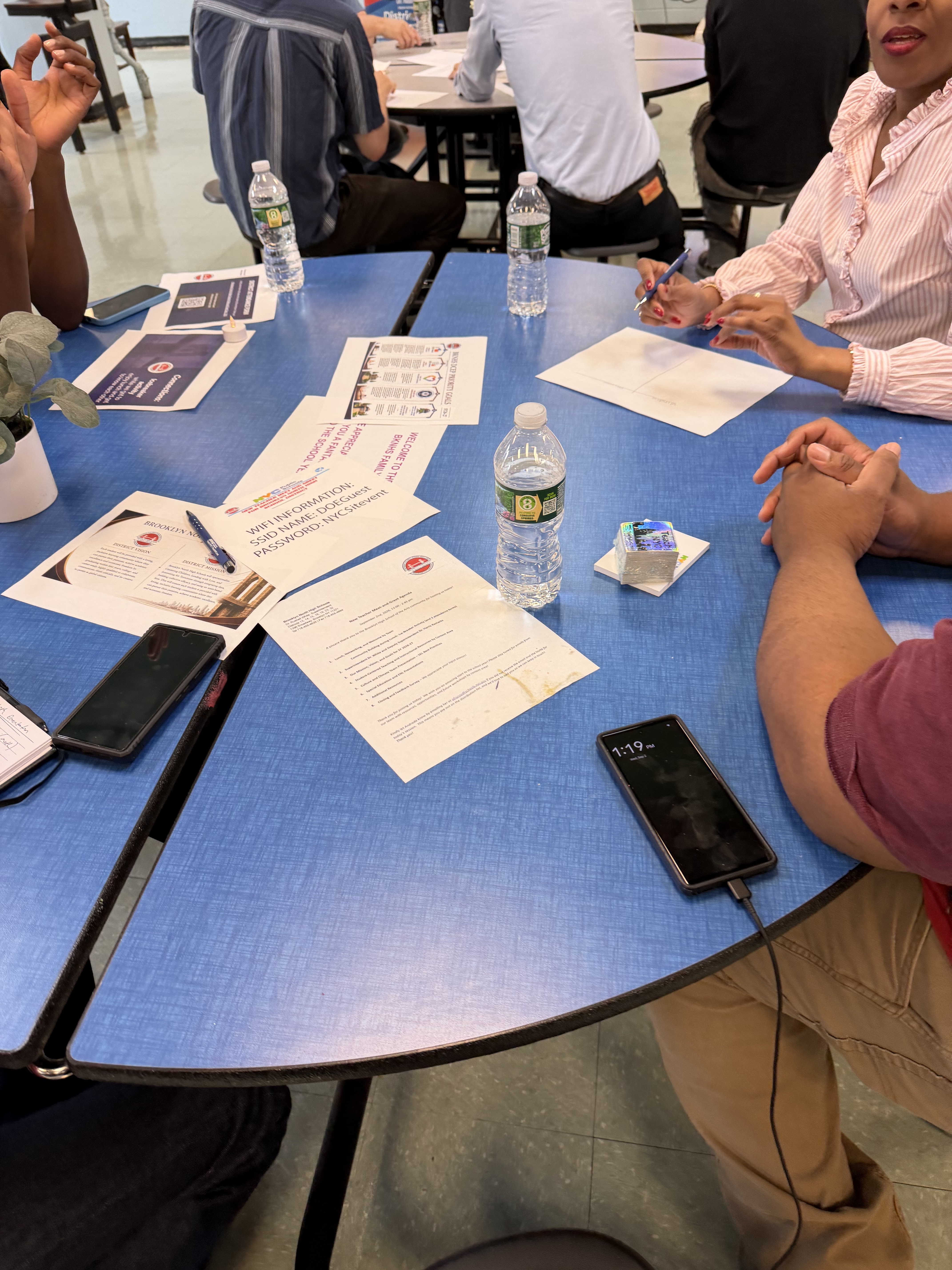 Adults gathered at a table during a school training session