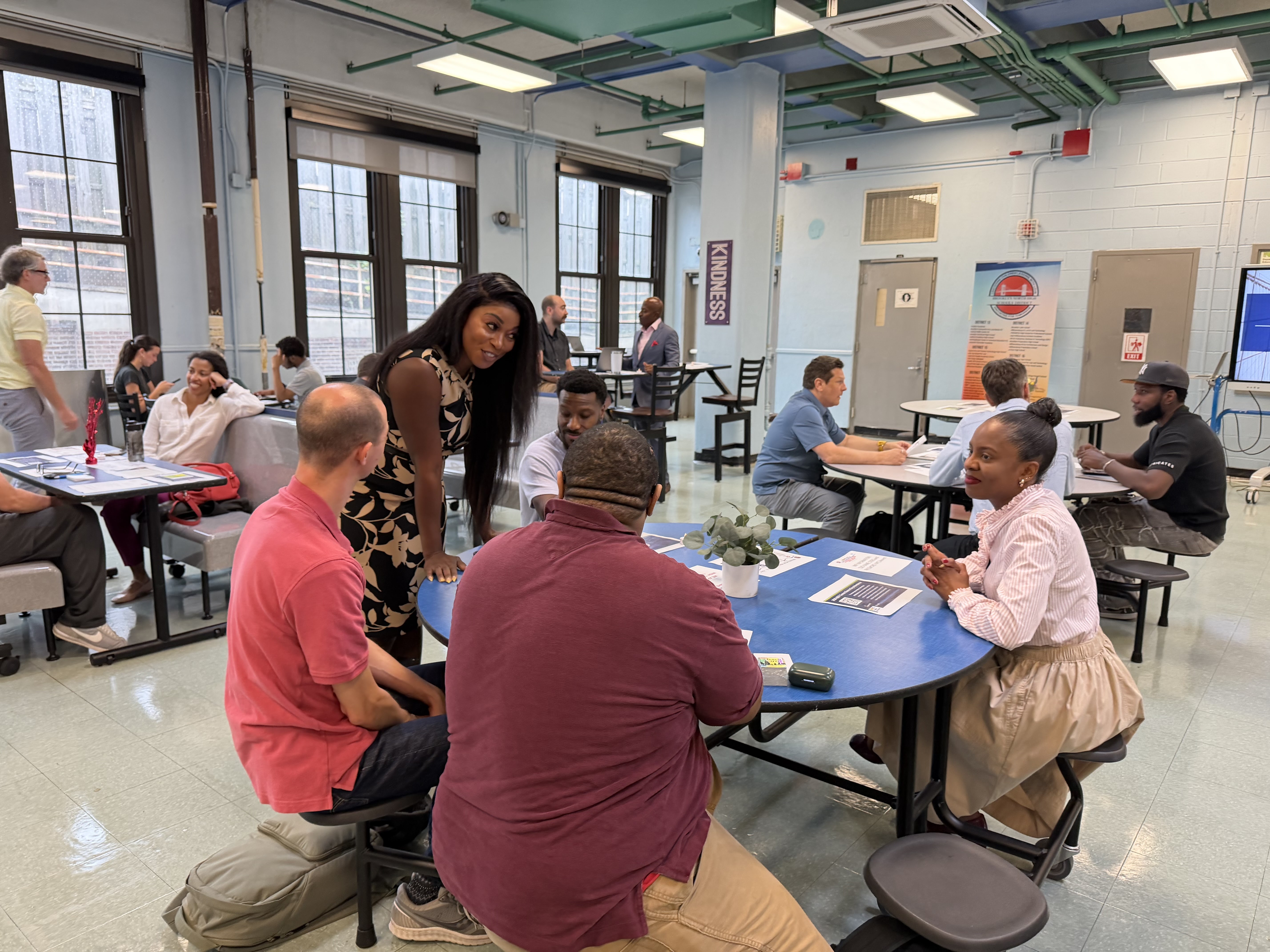 Adults gathered in school cafeteria during a community networking event