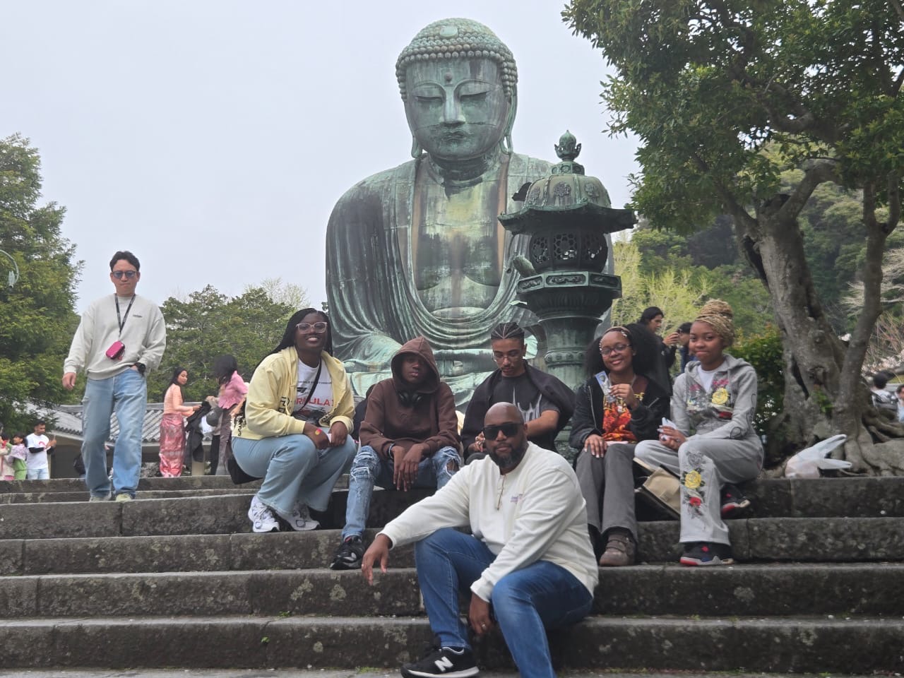 Students and chaperone posing at the Great Buddha of Kamakura Japan